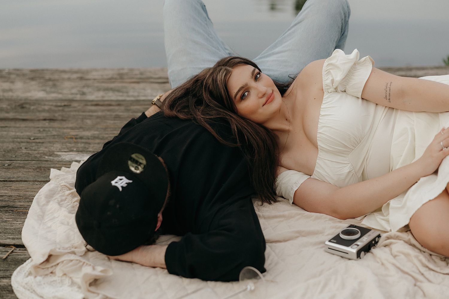 A series of romantic black and white wedding photos showing intimate moments between a couple on a beach at sunset.