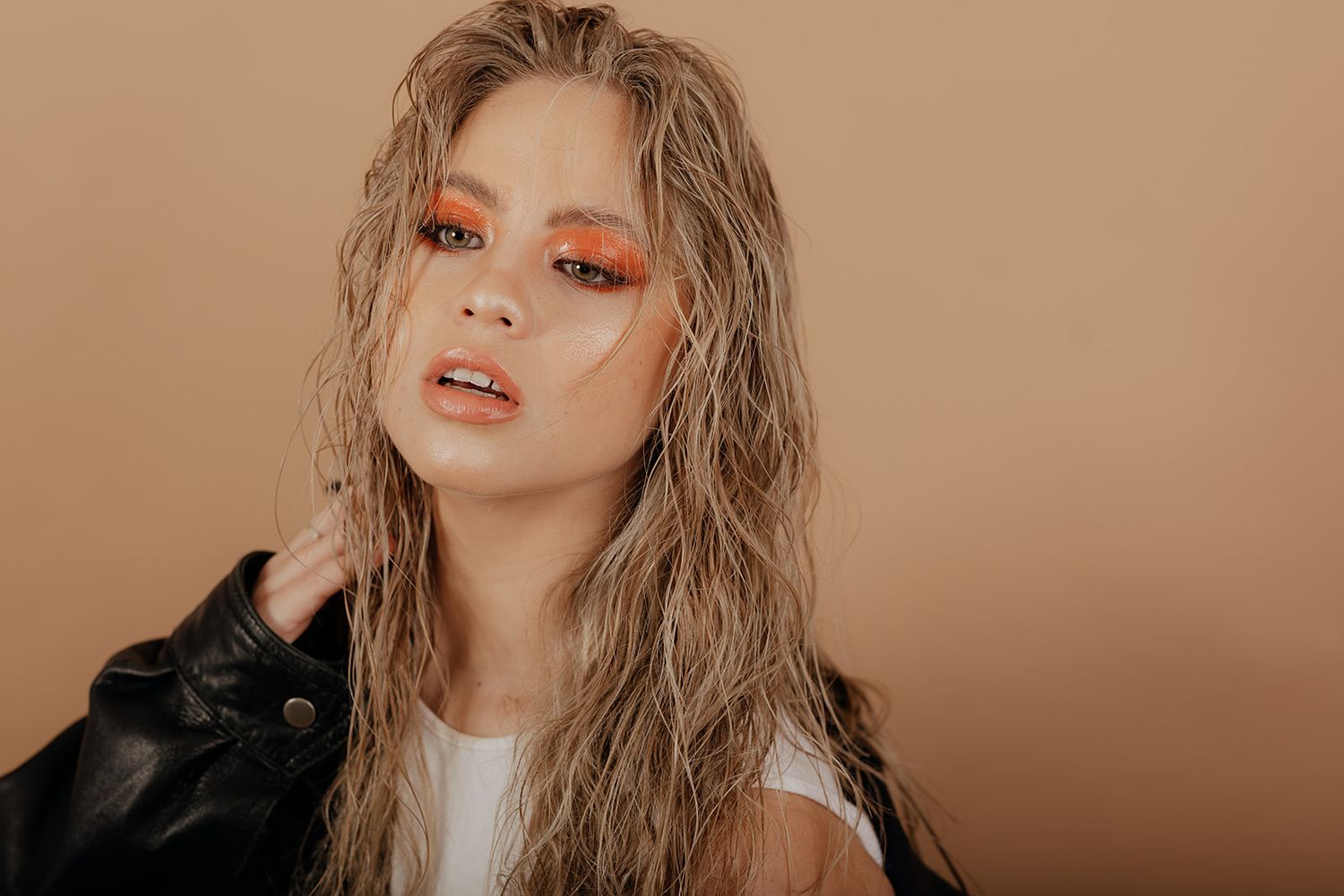 A series of moody artistic portrait shots with warm tones showcasing long blonde hair and dramatic lighting effects.