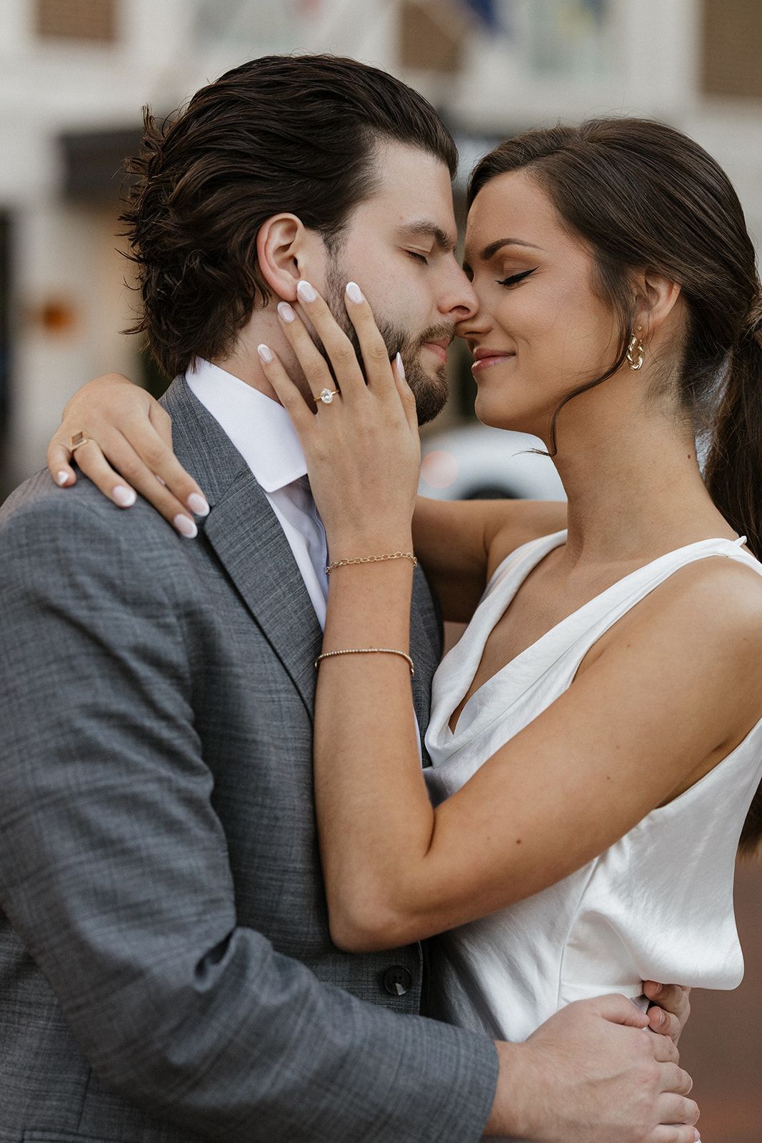 Intimate moment between couple sharing a tender embrace in formal attire.