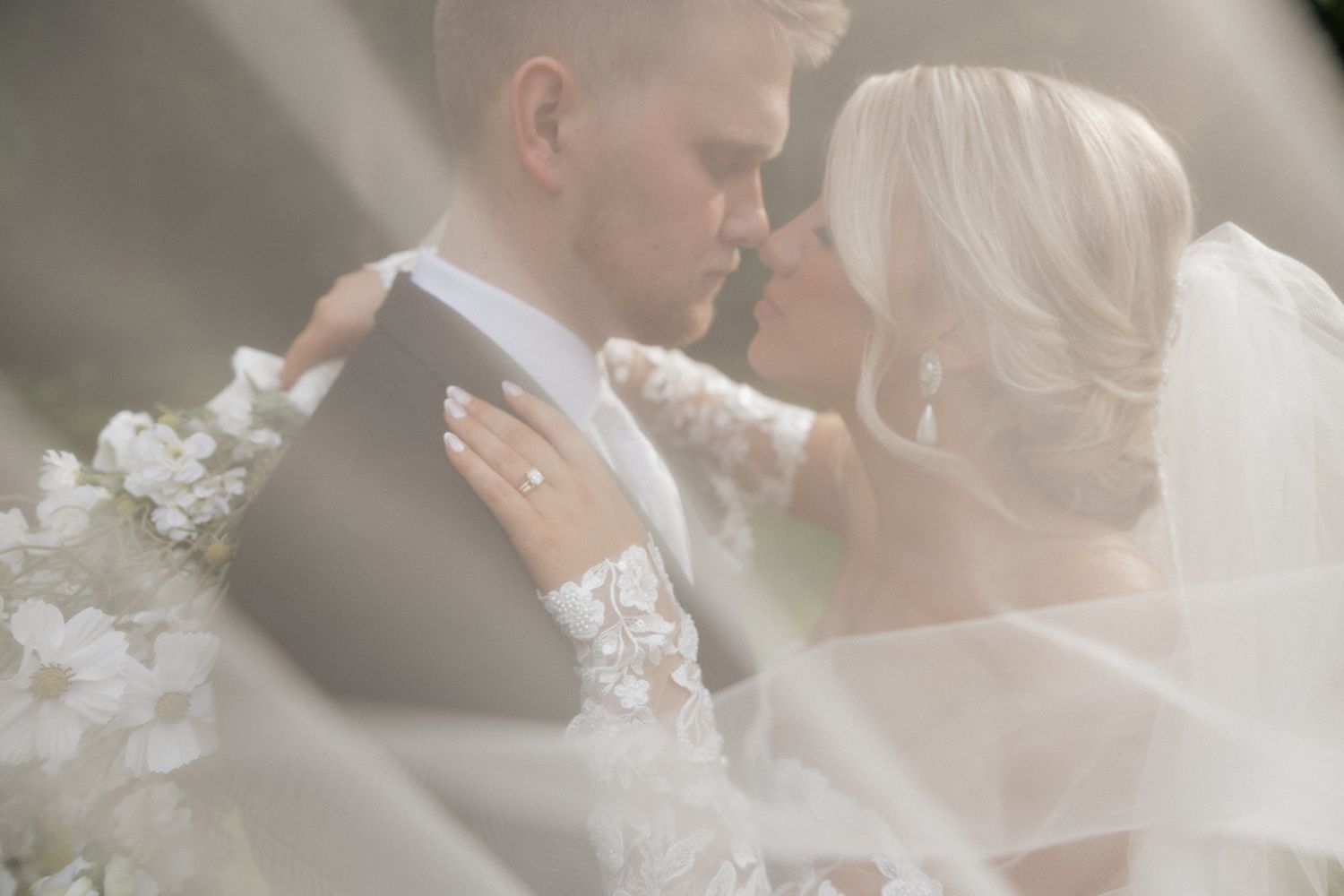 Romantic moment between newlyweds captured through soft focus lens.