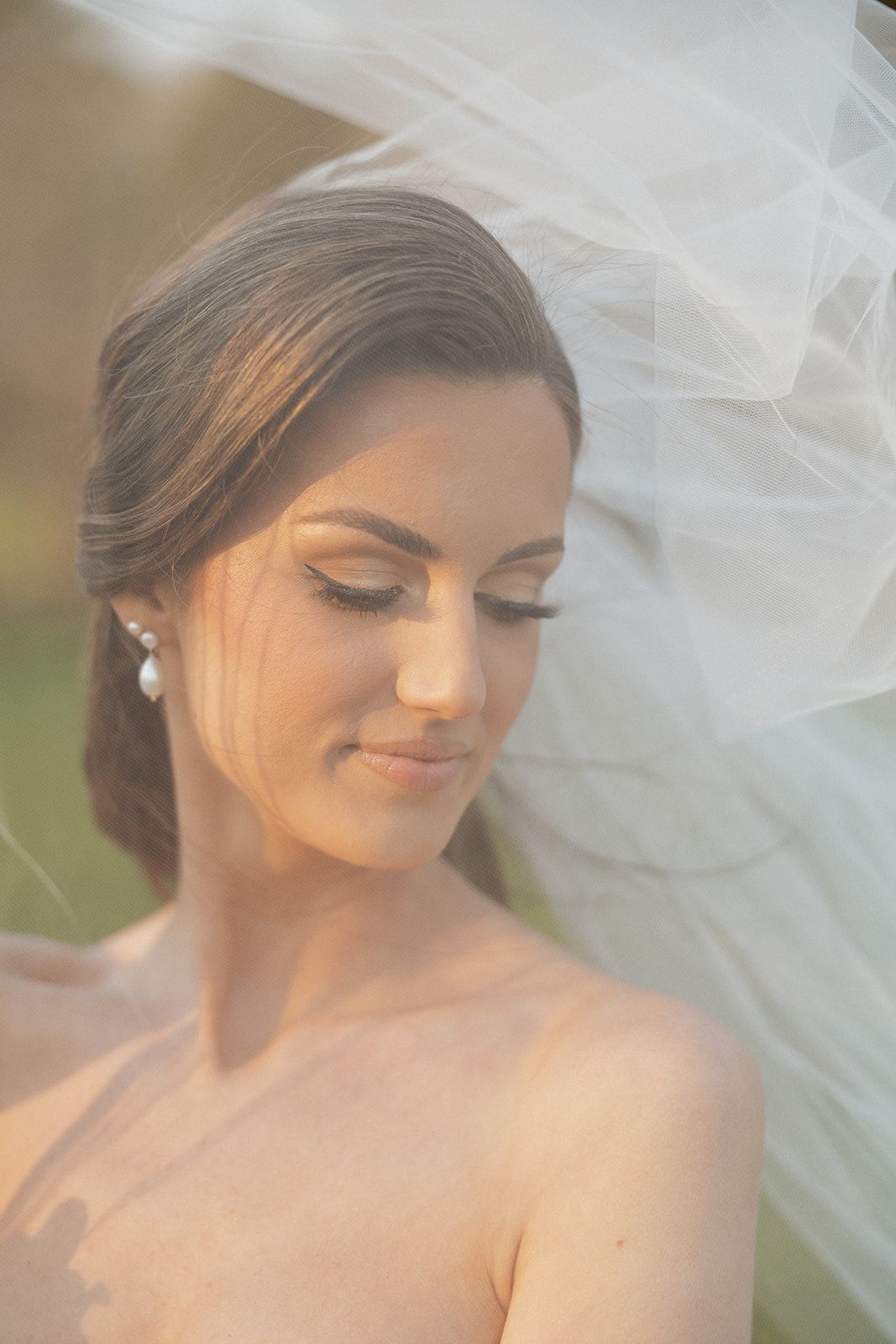Bridal portrait showing ethereal veil movement and delicate lighting with soft focus effect.