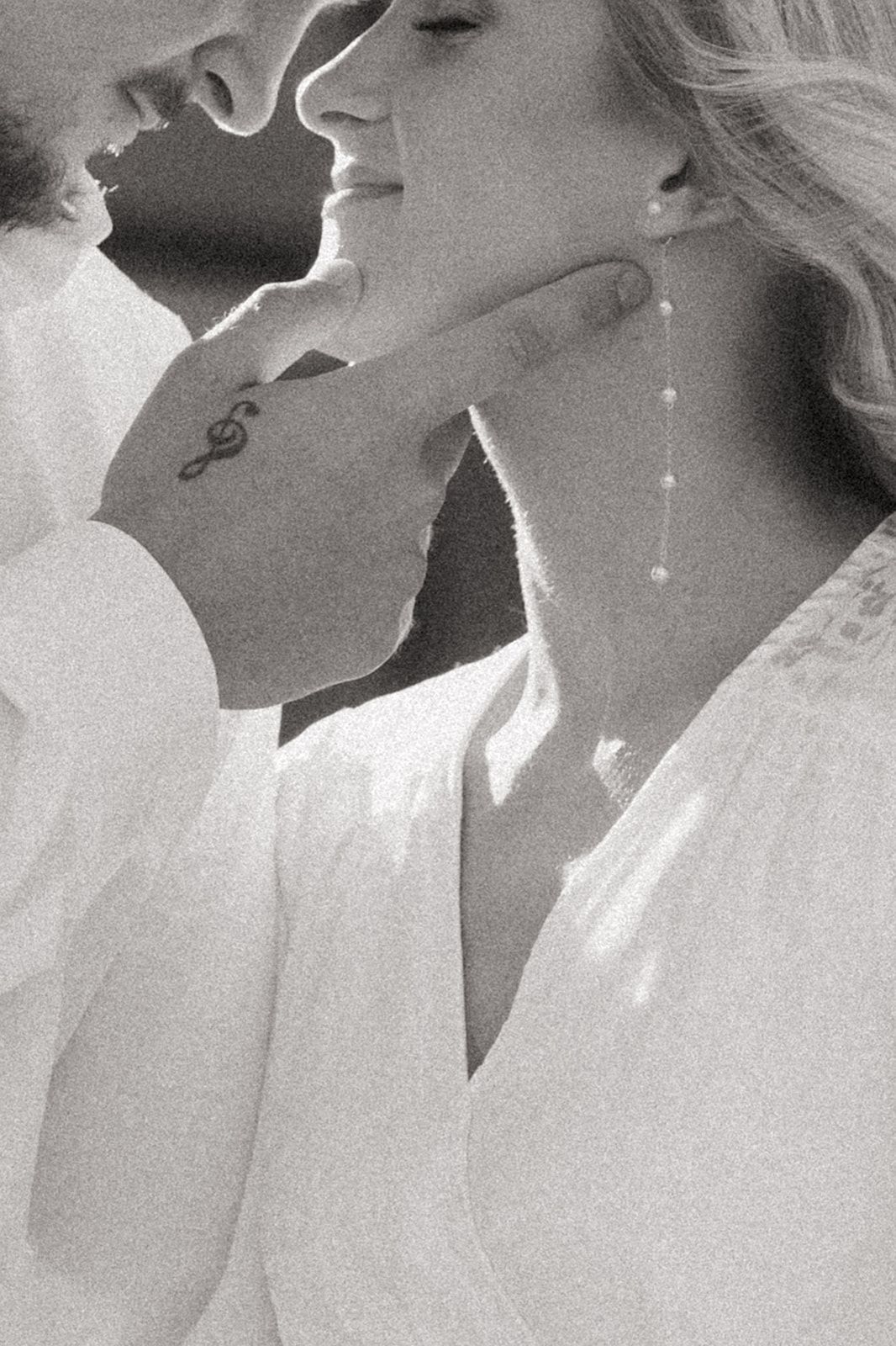 Black and white romantic photo series showing closeup of couple kissing in elegant formal attire.