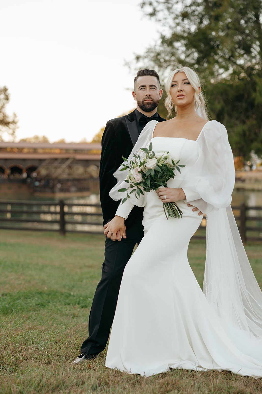 Elegant wedding portraits in an outdoor setting with rustic fencing and greenery.