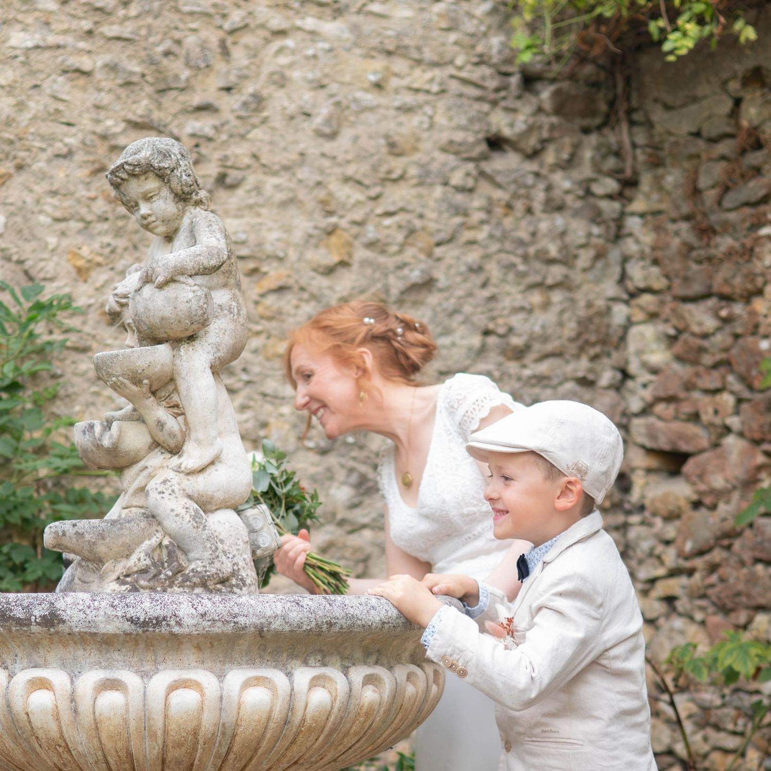A series of vintage stone water fountains and decorative garden sculptures in a rustic outdoor setting.