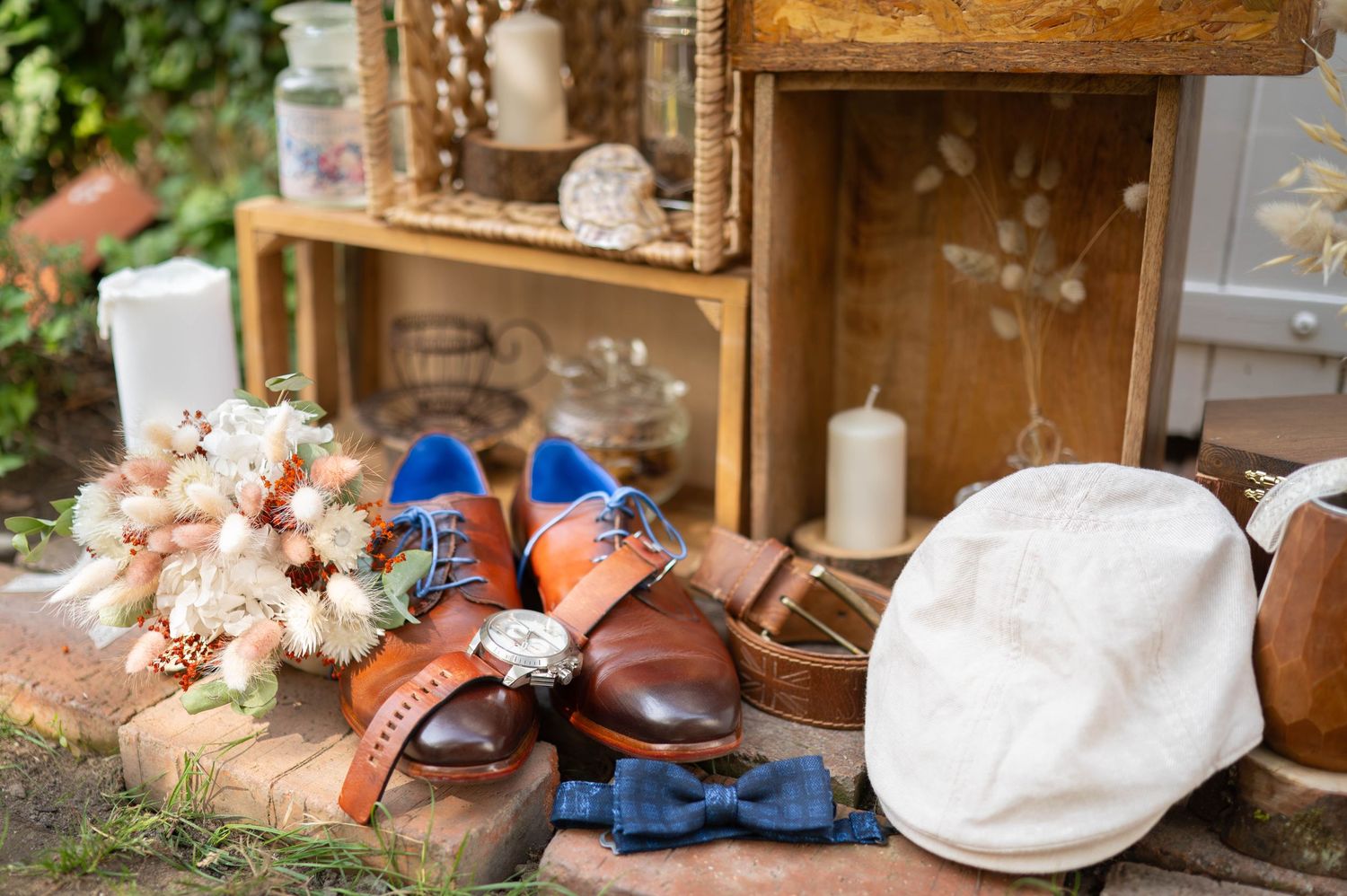 Brown leather football rests among delicate pink and white flowers with rustic wooden decor in the background.