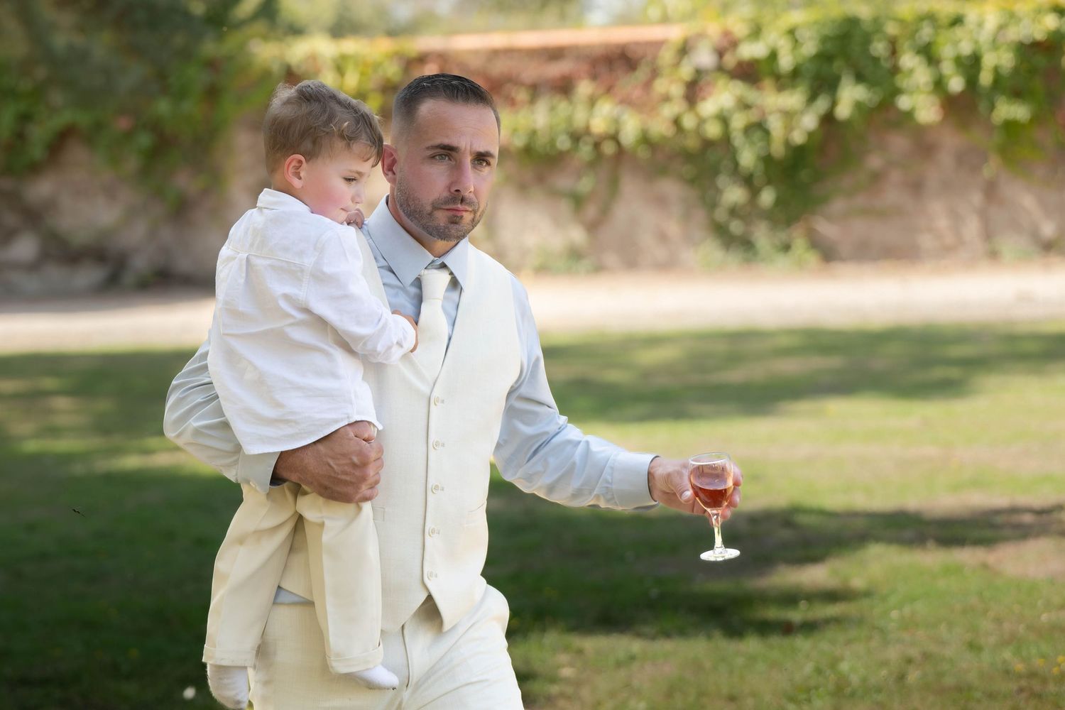 A series of wedding photos showing joyful moments between a couple in white attire outdoors.