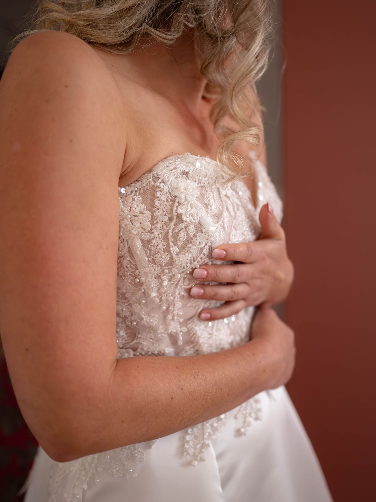 Close-up detail shots of a white lace wedding dress bodice with delicate beading and strapless neckline.