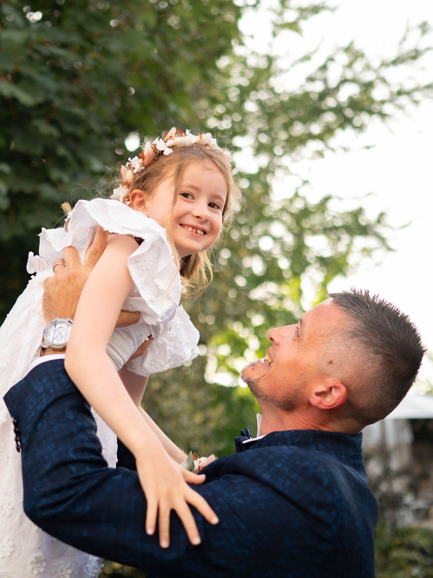 A joyful moment captured in a sequence showing playful interaction between two people outdoors in a natural setting.