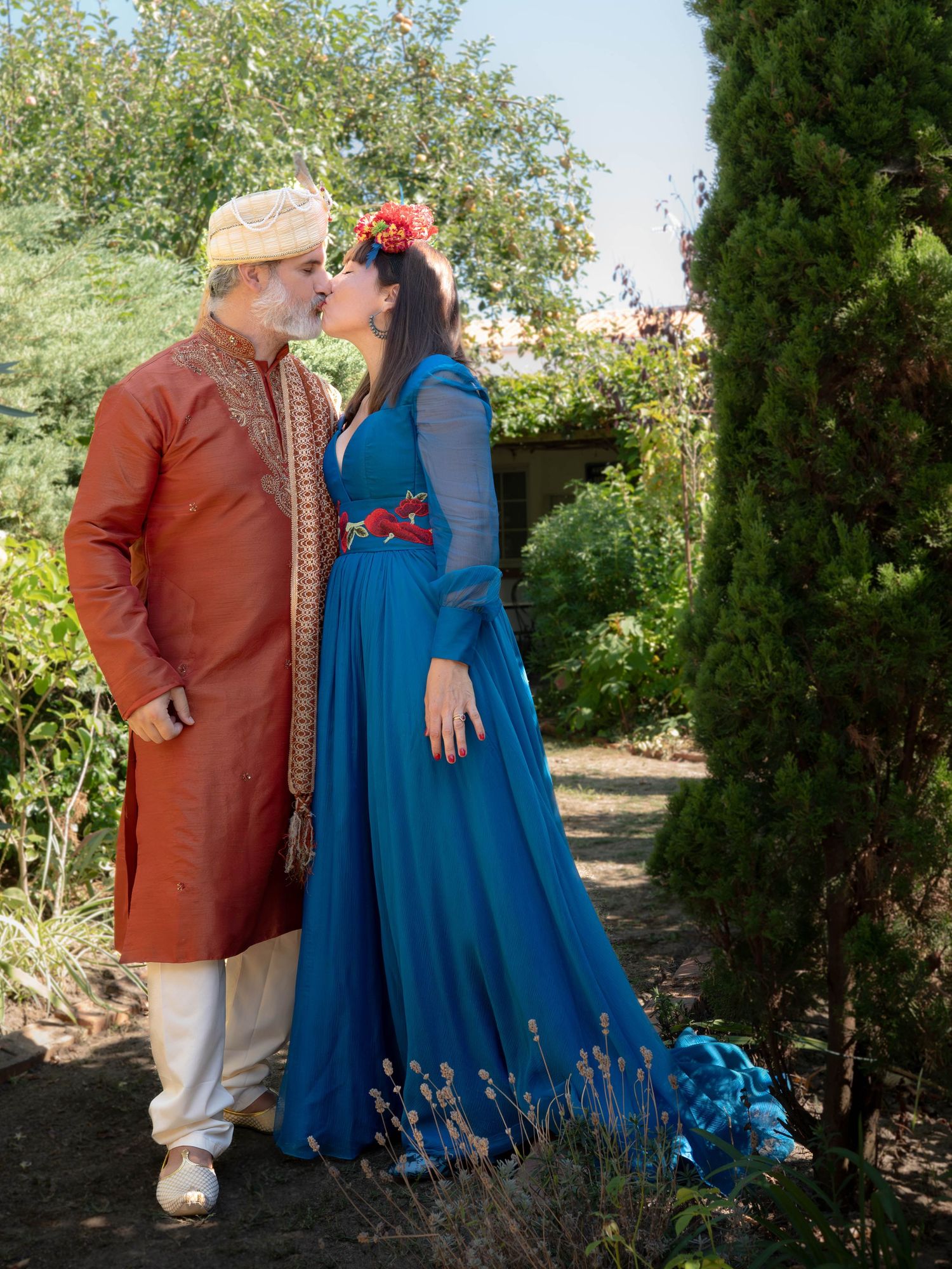 Romantic garden photoshoot featuring blue and brown formal attire.