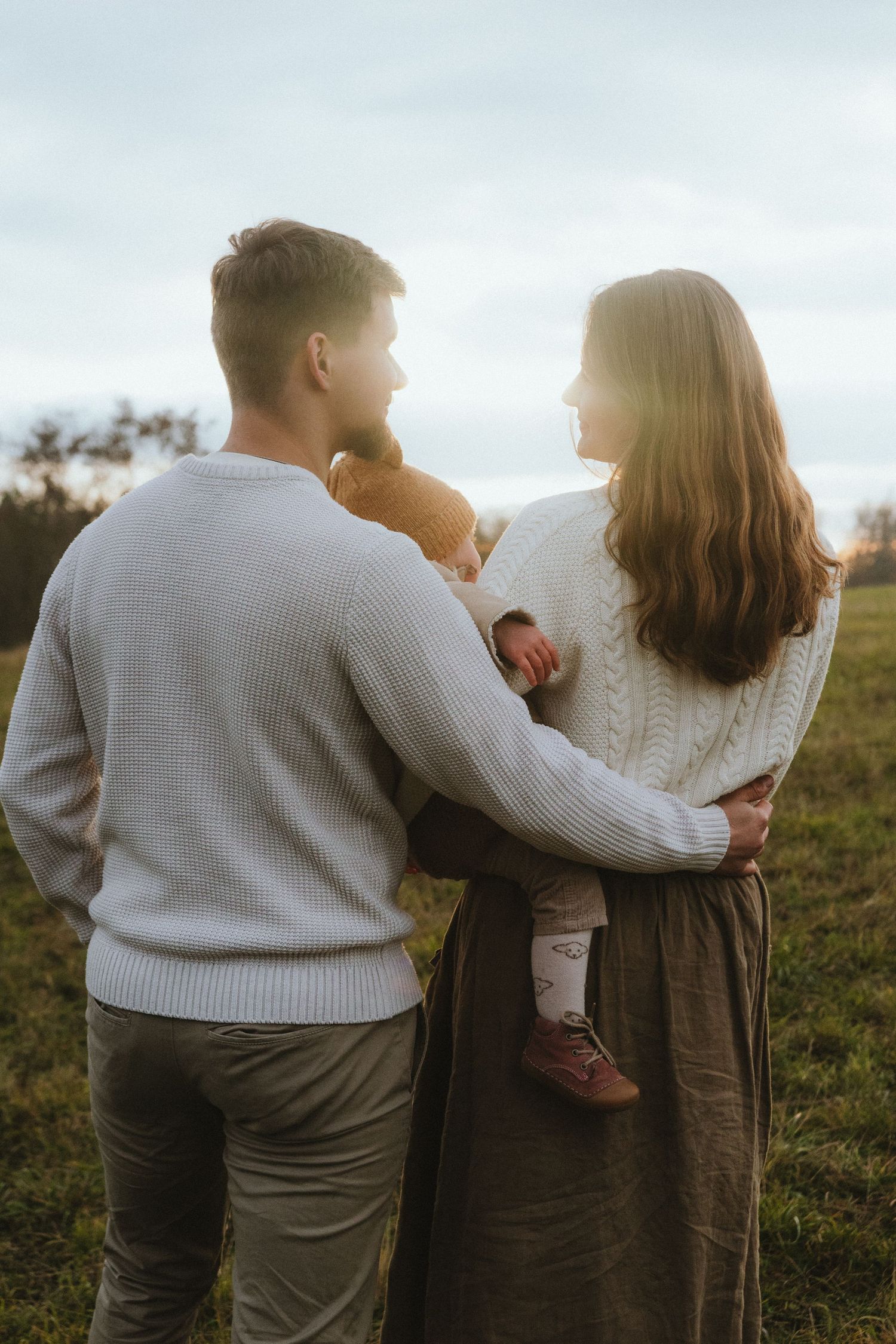 Intimate outdoor portrait series of people in sweaters during golden hour.