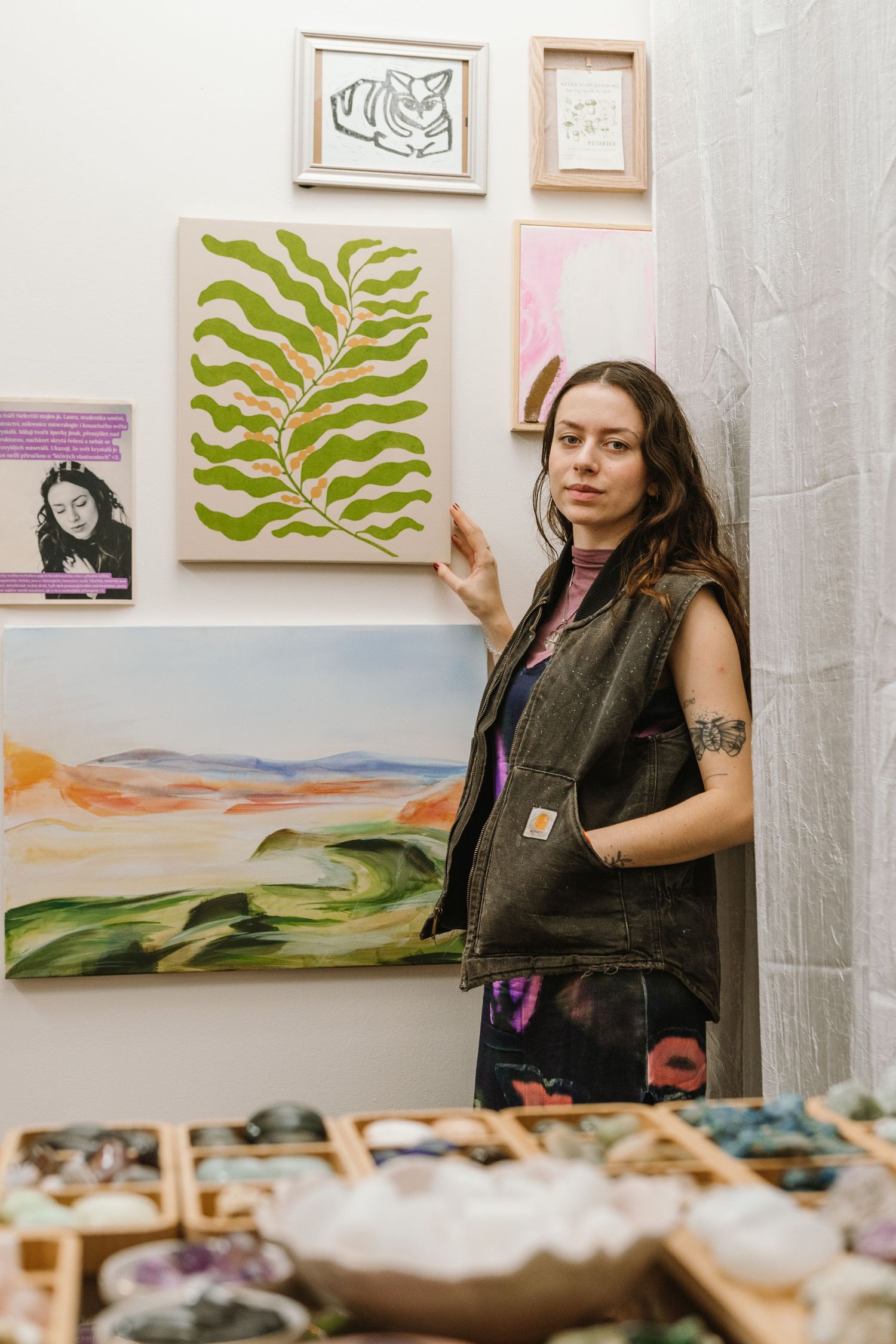 Art studio space showing botanical artwork and nature-inspired paintings on display.