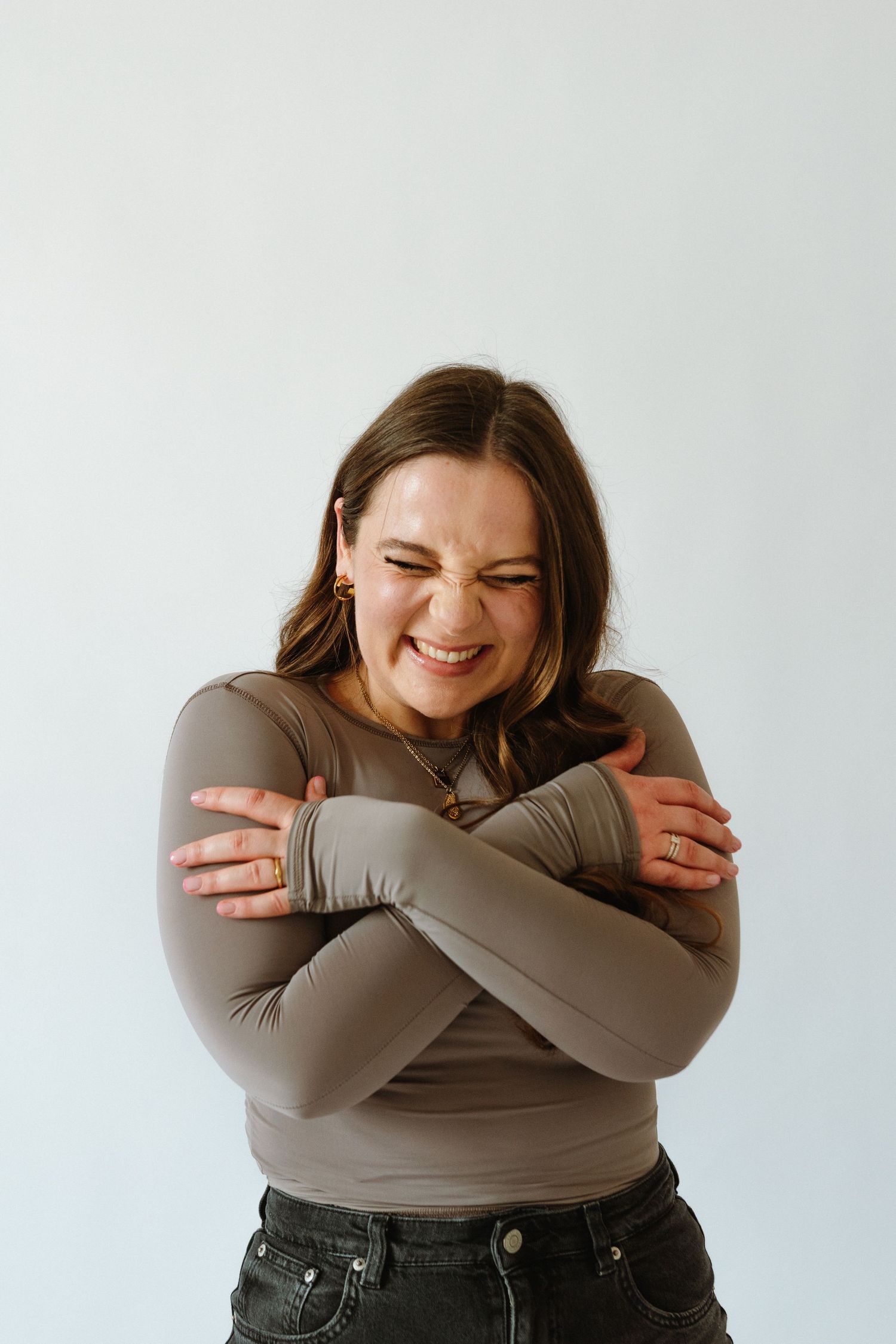 A joyful portrait against a white background showing genuine emotion and happiness.