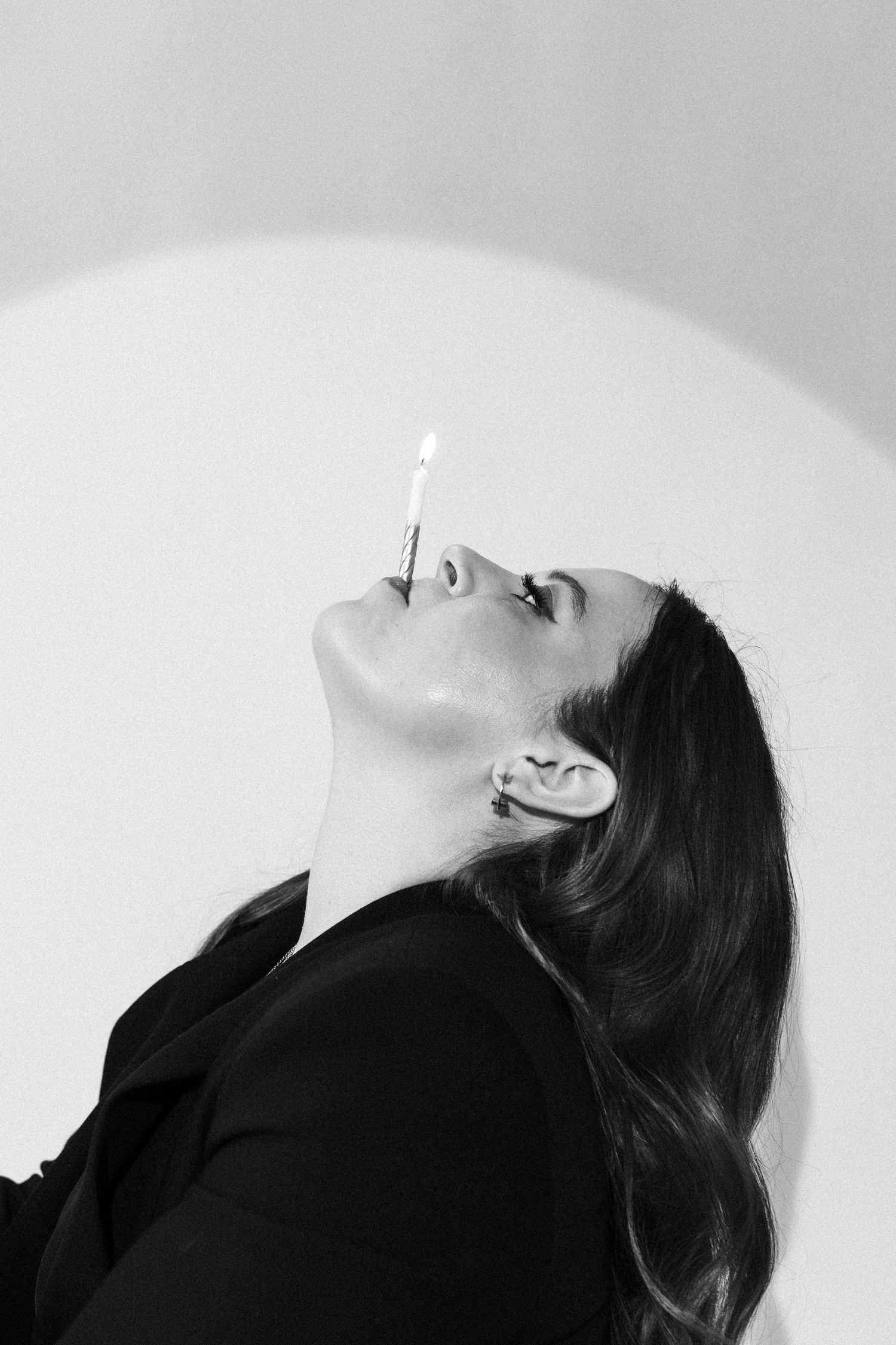 Dramatic black and white profile shots of someone looking upward against a light background.