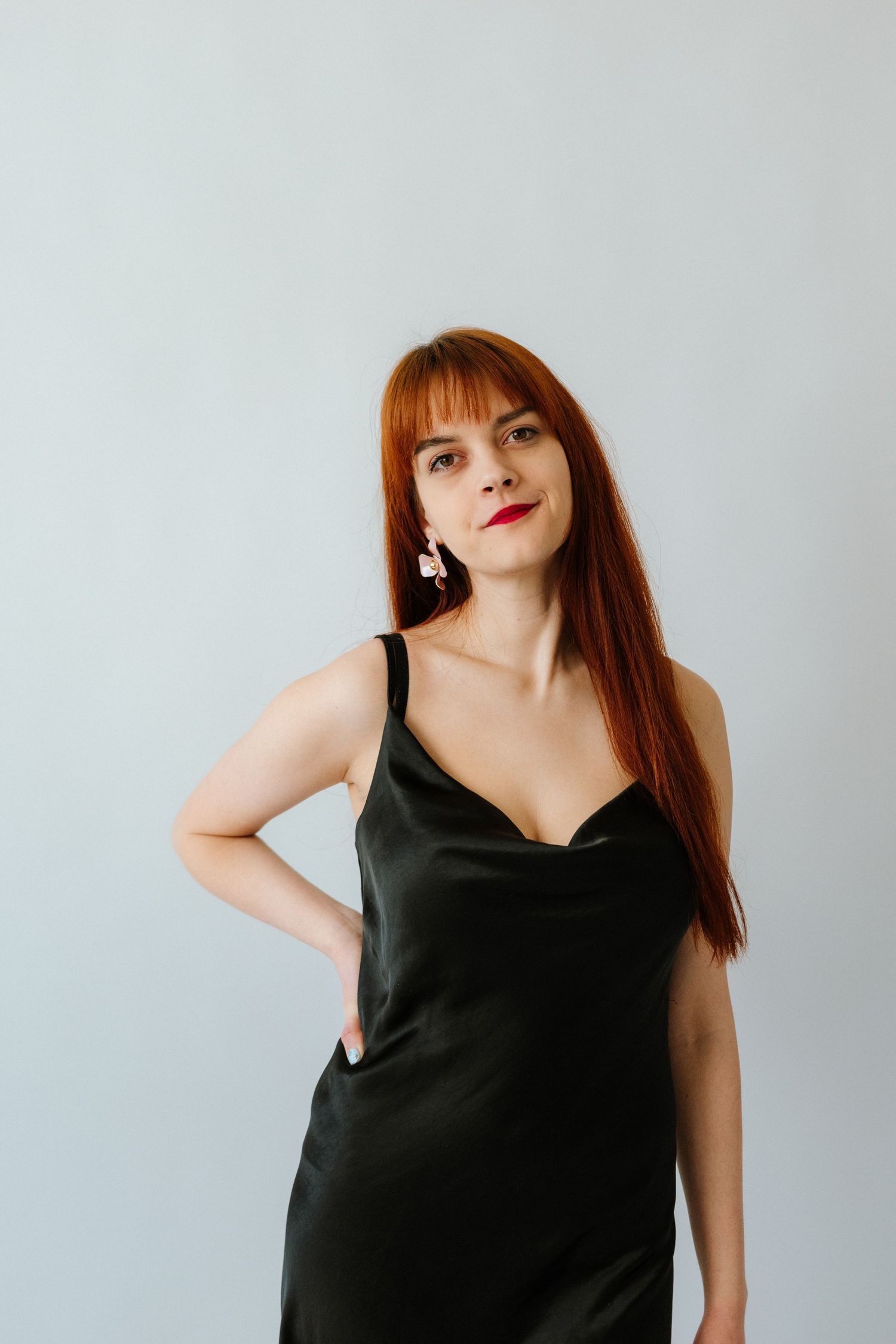 Fashion portrait series showing a model in a black sleeveless top against a light background.