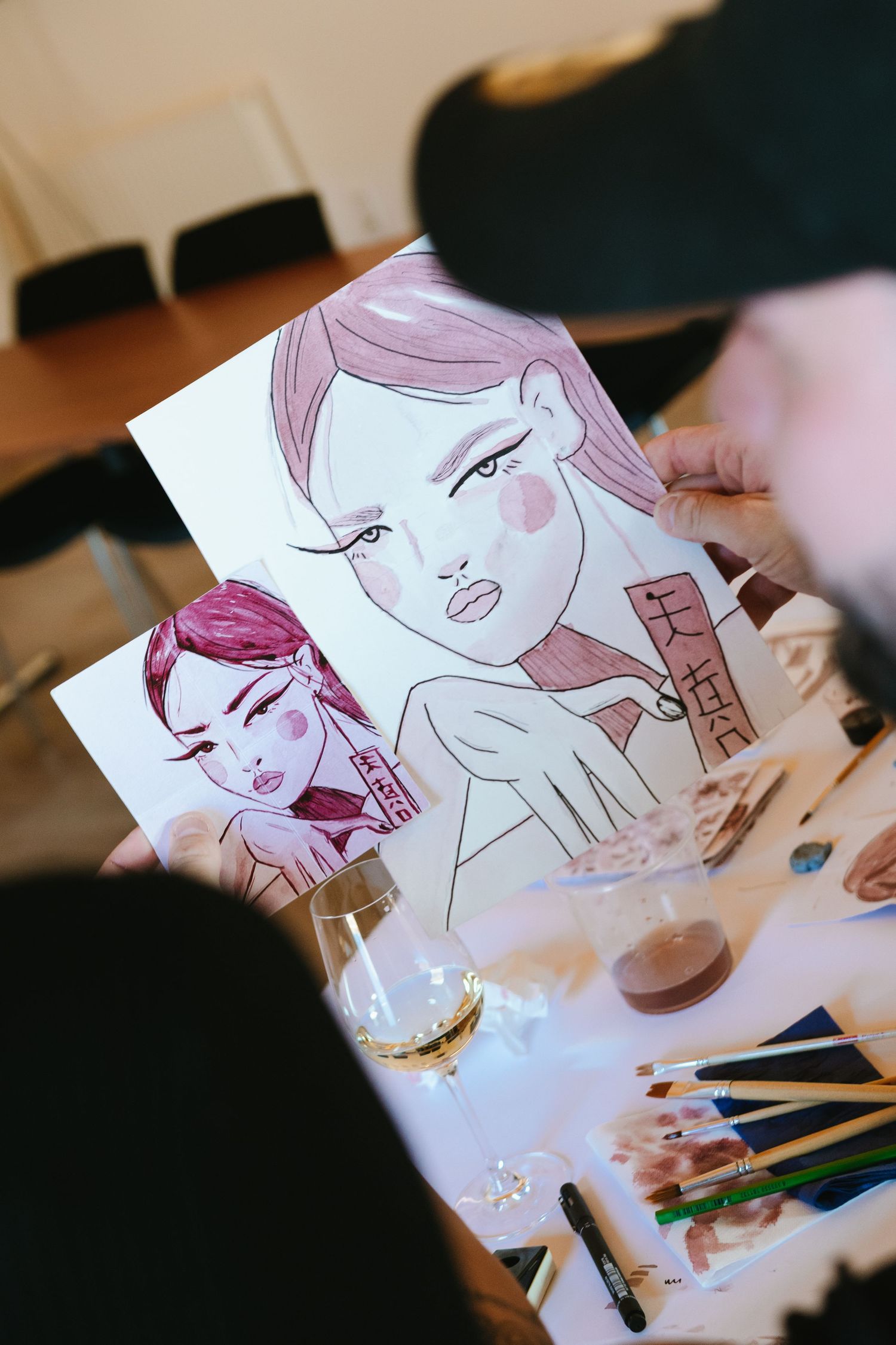 Artistic illustration of a feminine face being drawn on white paper.
