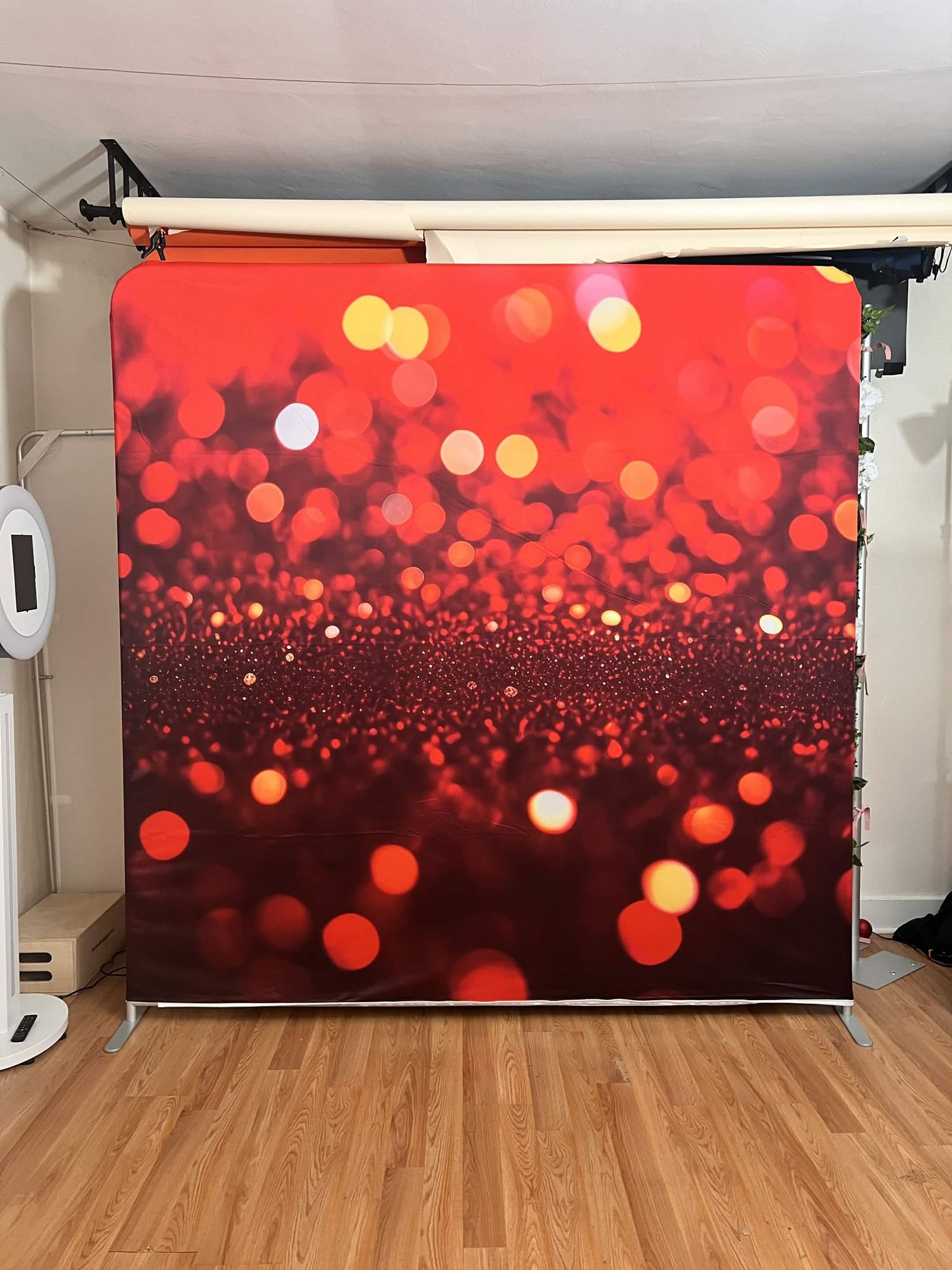 A red glitter bokeh photography backdrop with sparkling lights for photo booth studios.