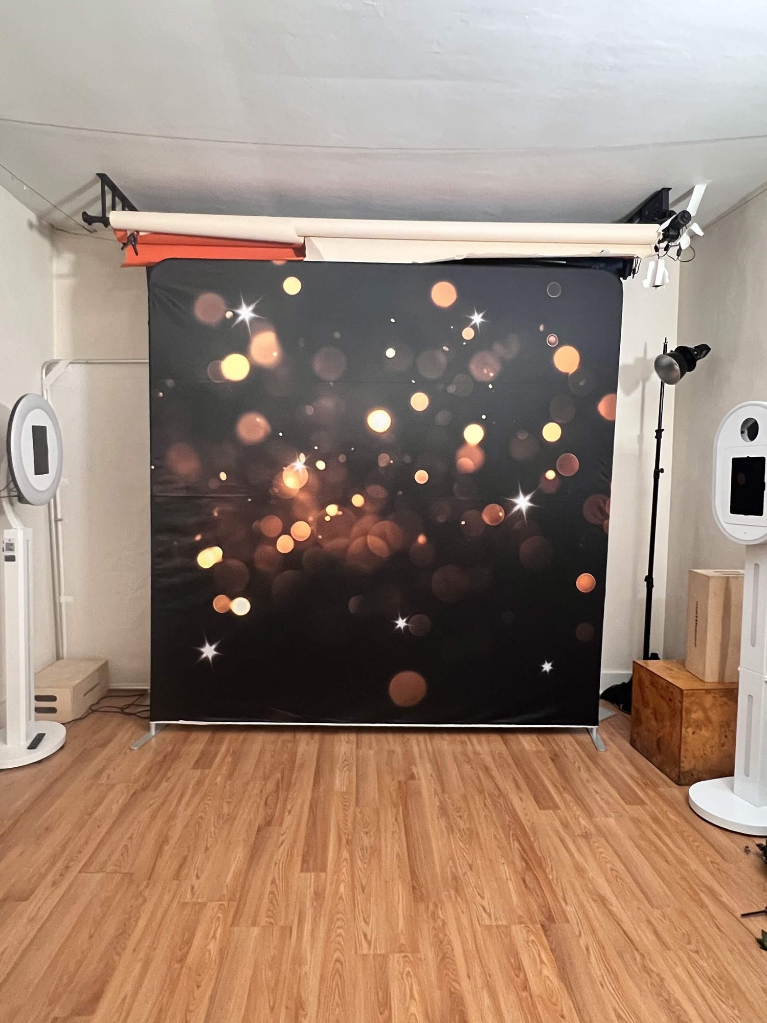 A dark bokeh sparkle photography backdrop with golden glowing lights for photo booths.