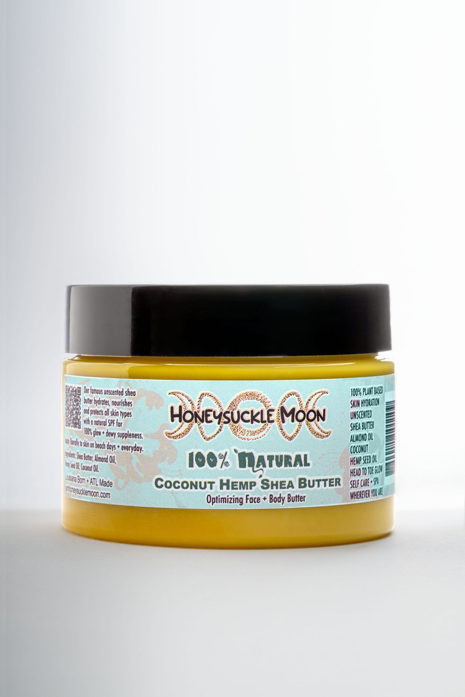 A jar of natural coconut hemp shea butter skincare product from Honeysuckle Moon shown from different angles.