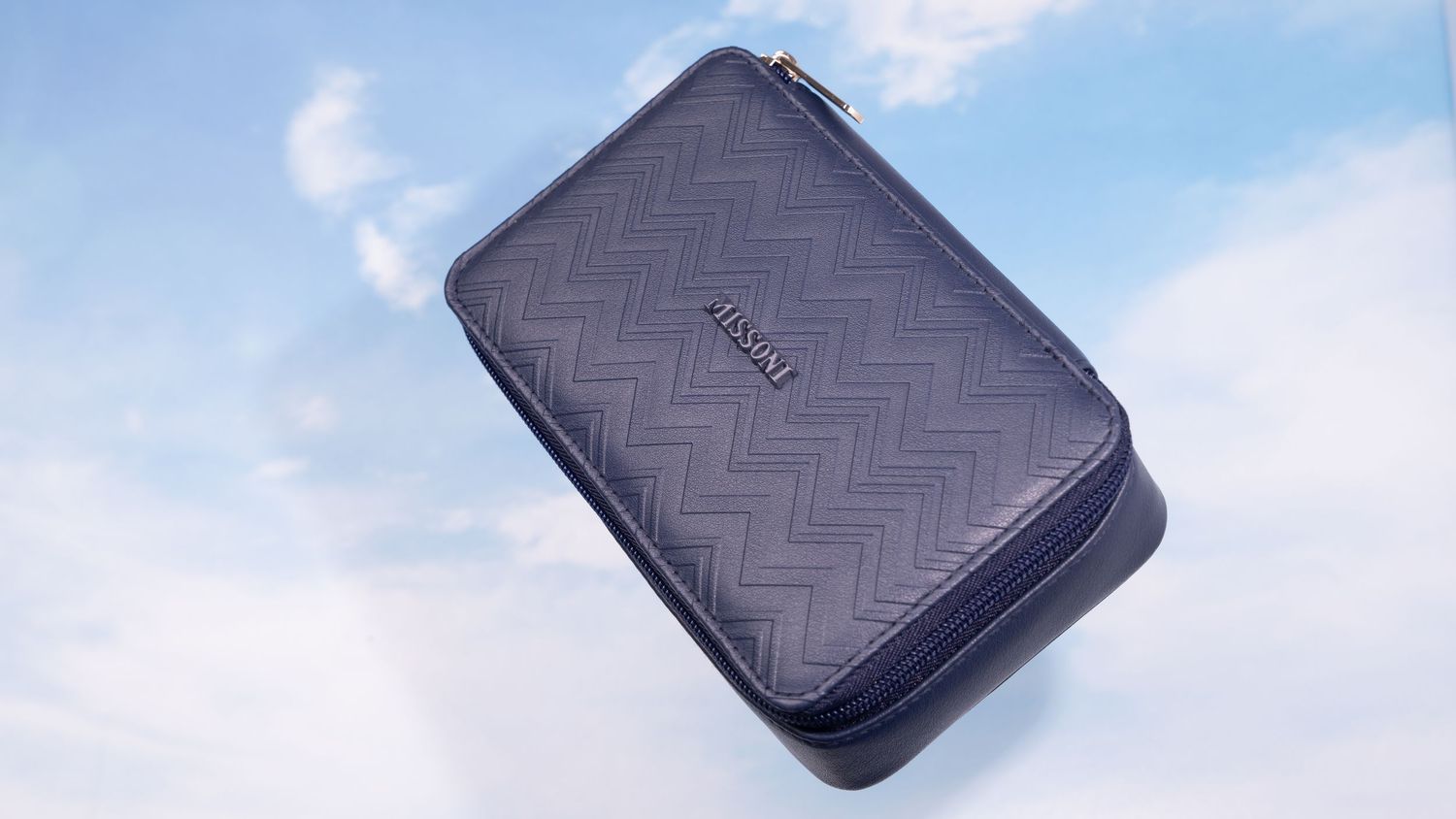 Black leather wallet shown from multiple angles displaying textured surface and compact design.