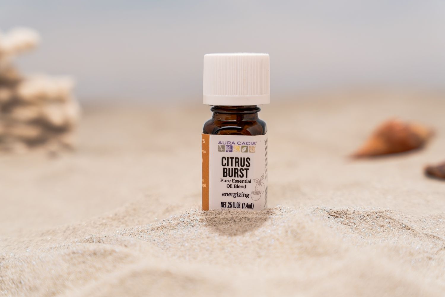 Brown glass supplement bottles arranged on textured beige sand surface in natural lighting.