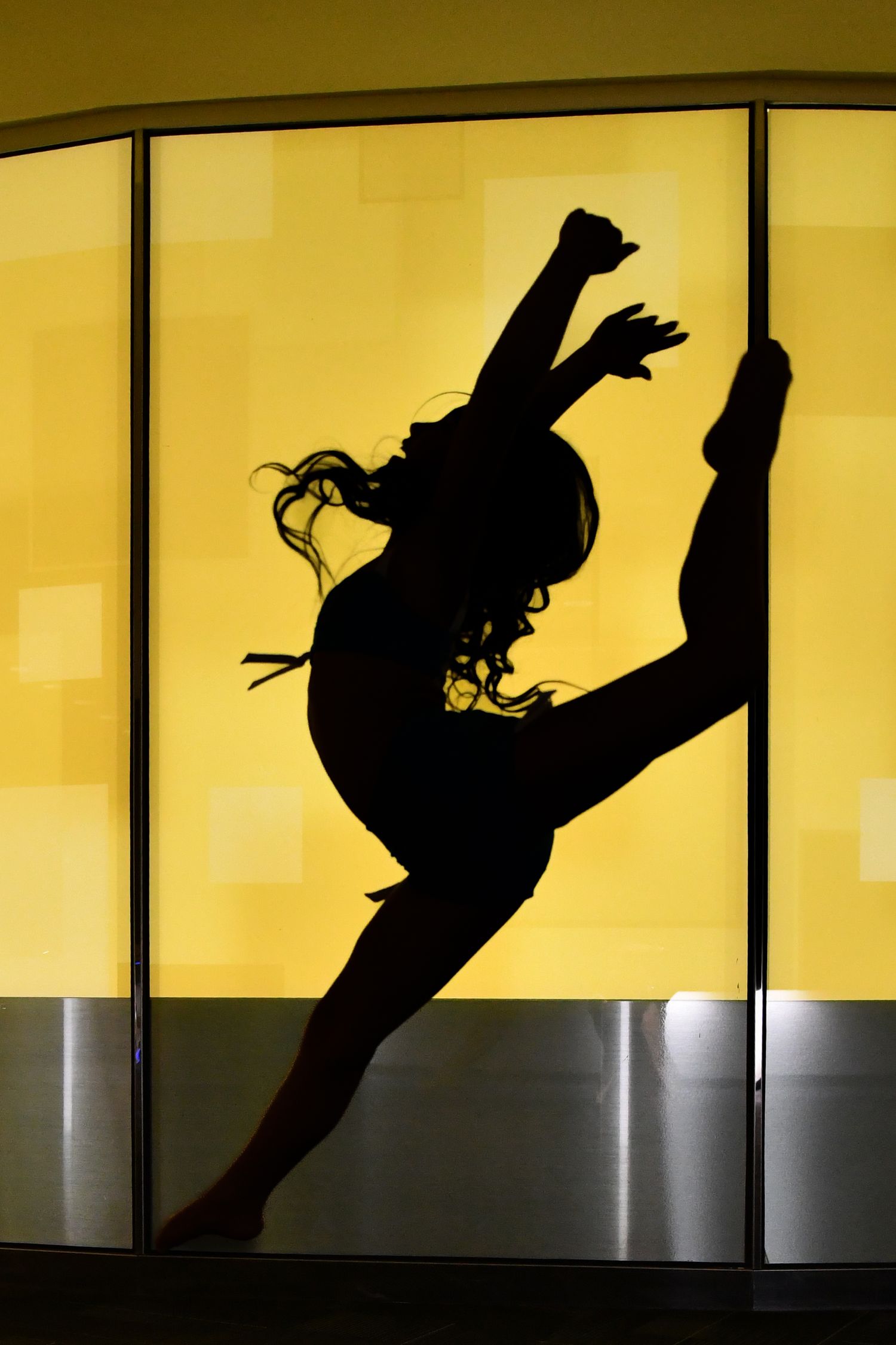 High‑energy dance silhouette captured mid‑air against a vivid yellow background at NUVO Detroit
GM renaissance center
Detroit Northville Mic