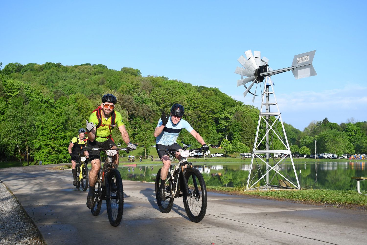 cyclists pedaling together on a forested road during outdoor ride Mohican gravel