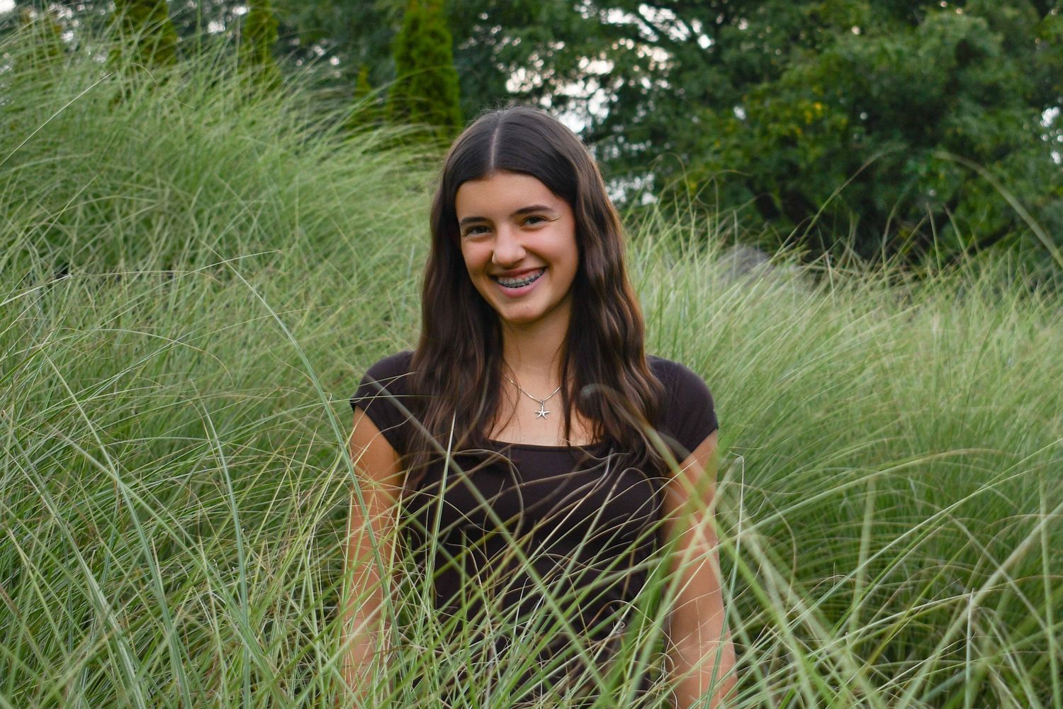 Timeless - Portrait with subtle luxury touches, designed to remain relevant for years.
Natural senior portrait taken outdoors with greenery