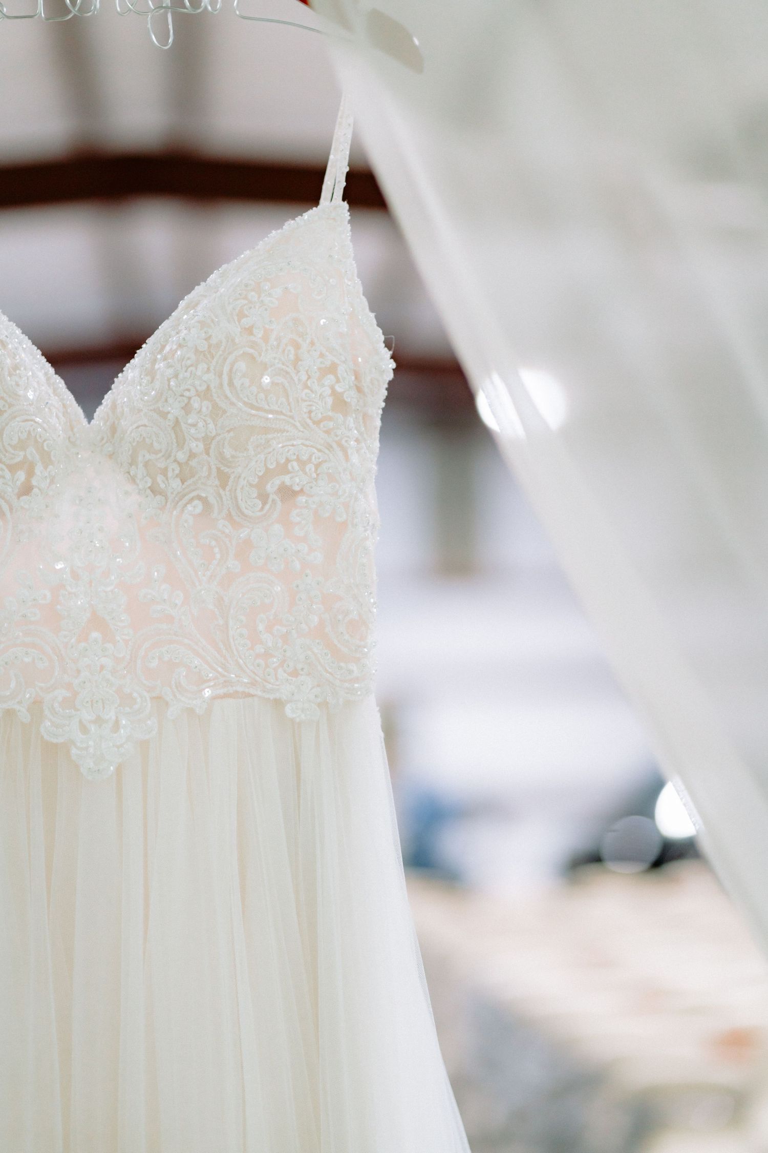 Detailed view of wedding dress bodice featuring romantic lace appliques and sweetheart neckline.