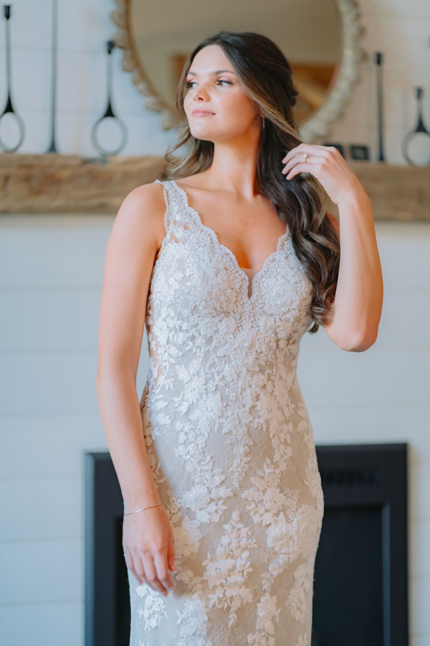 Beautiful lace wedding dress with form-fitting silhouette and intricate embroidery details.