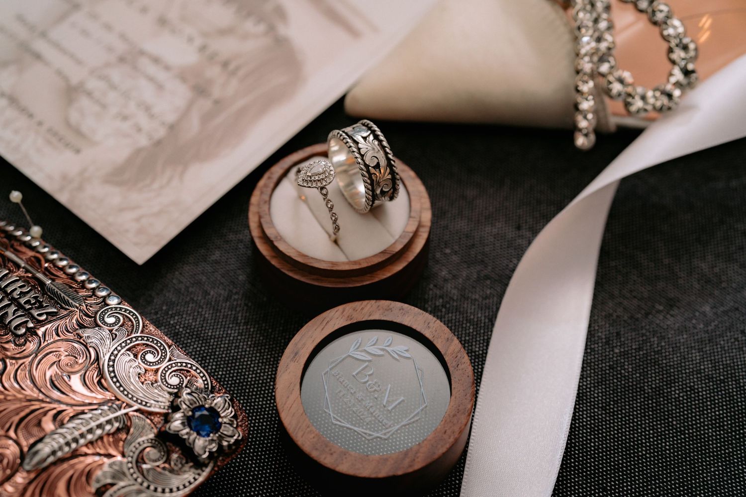 Wedding accessories and stationery artfully arranged showing fine details and textures.