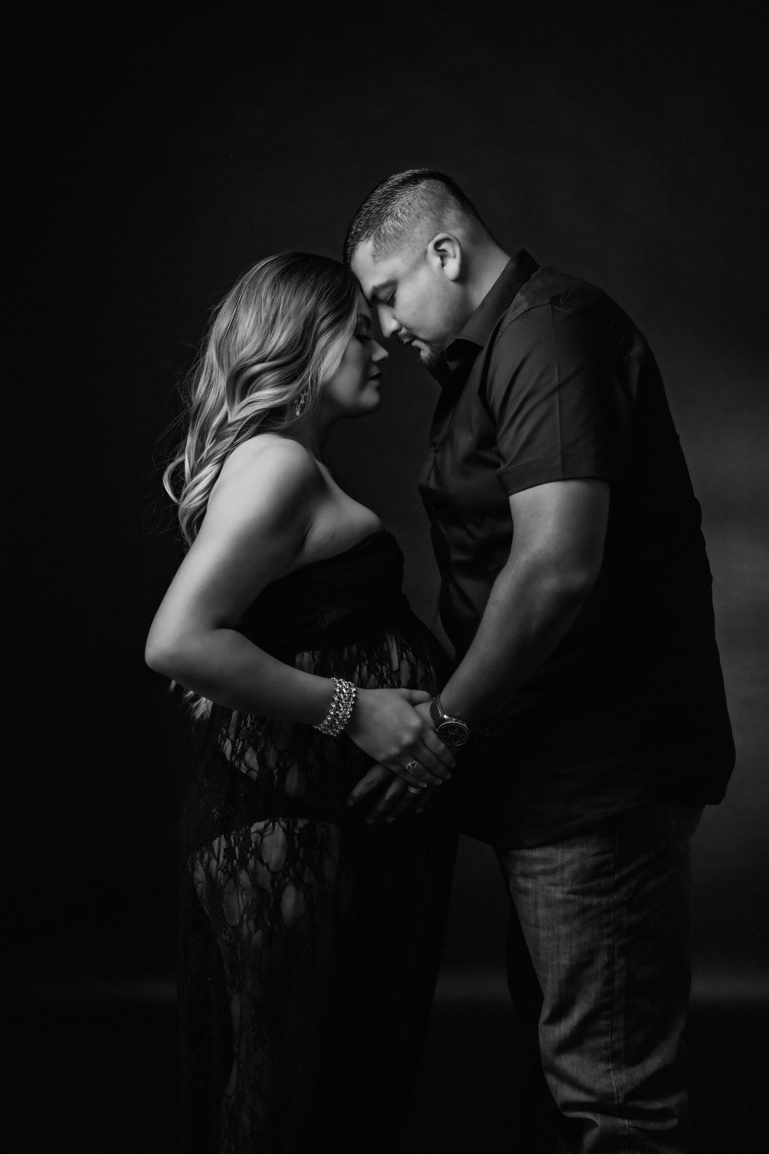 Intimate black and white maternity portraits showing connection between expectant couple.