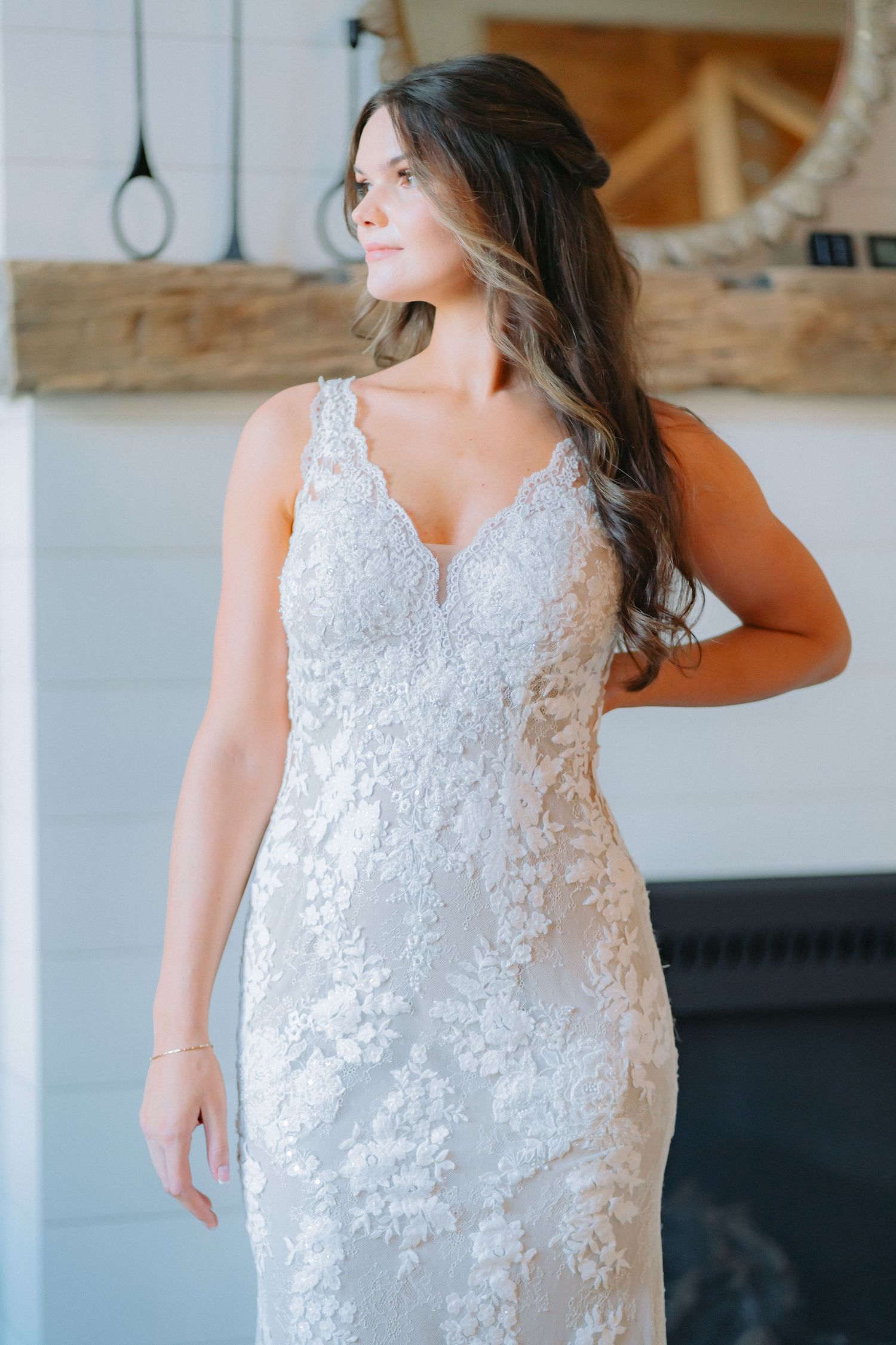 Fitted lace wedding gown with sweetheart neckline and elegant floral appliques.