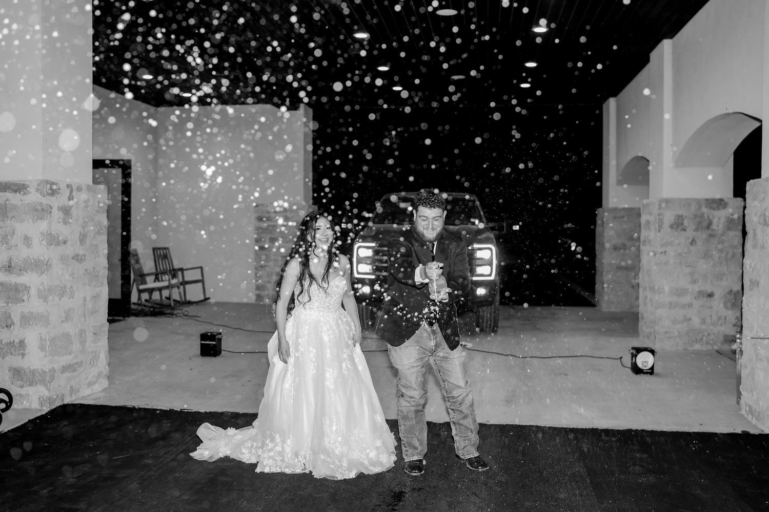 Sparklers illuminate the night as guests form a pathway during a romantic wedding send-off.