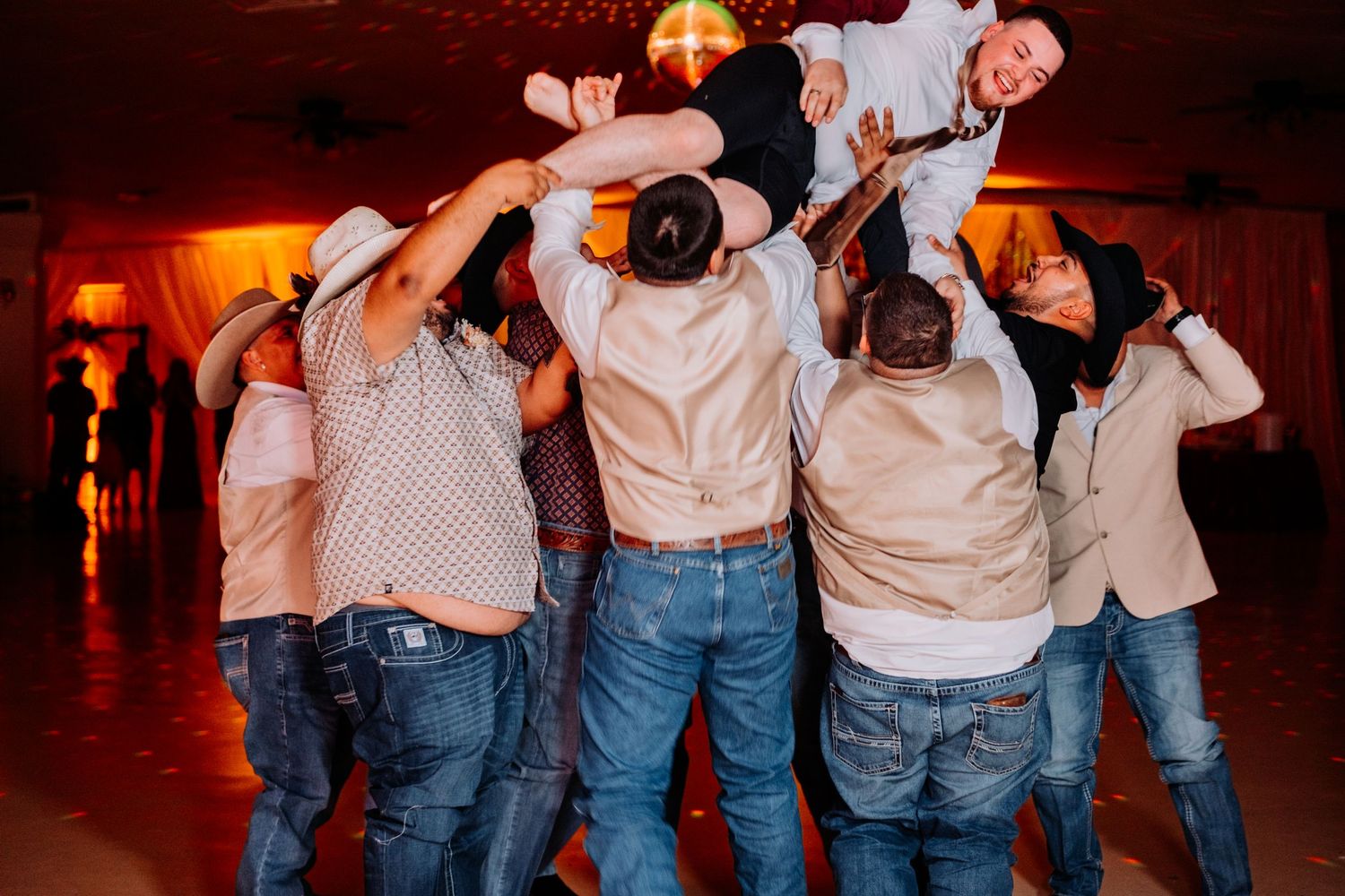 Wedding guests participating in synchronized dance moves at reception party.