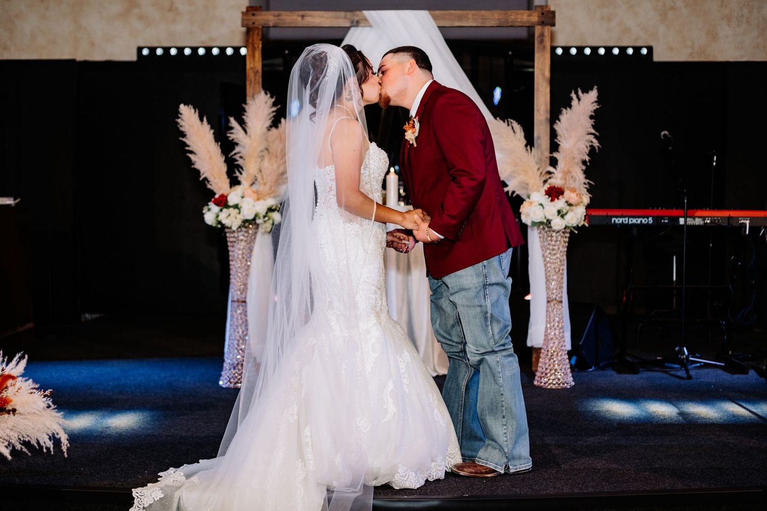 Wedding ceremony dance captured in dark dramatic lighting.