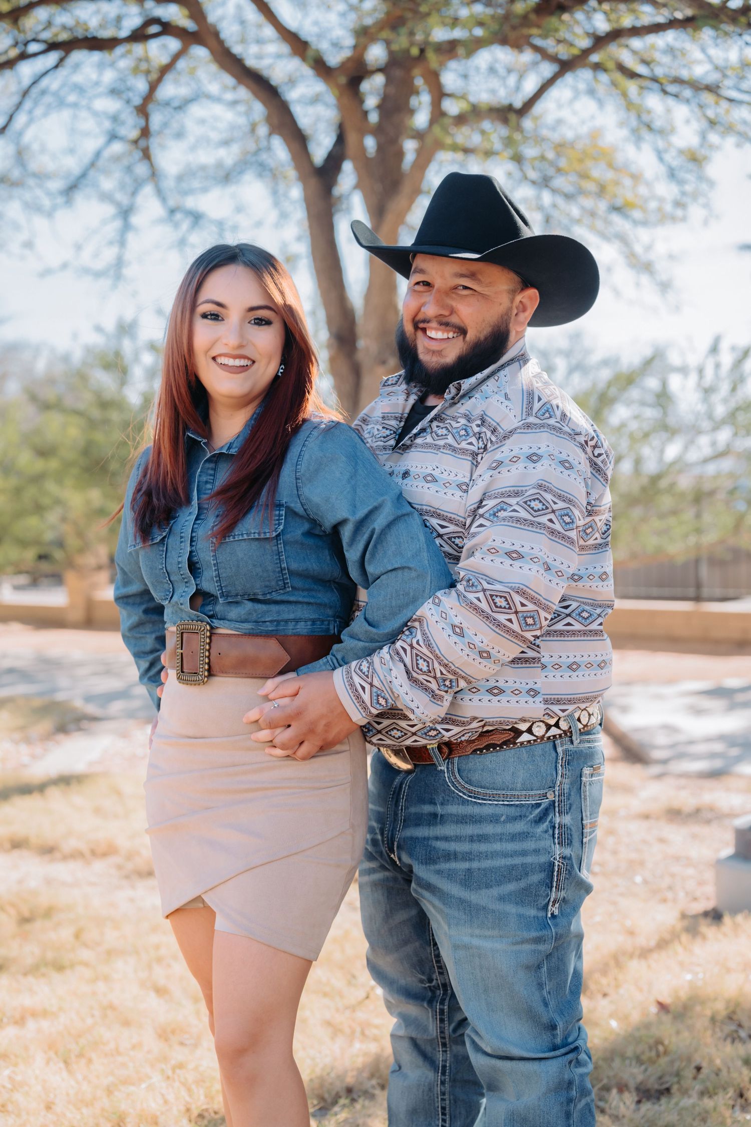 Candid moments captured between a couple in matching denim against a natural autumn backdrop.
