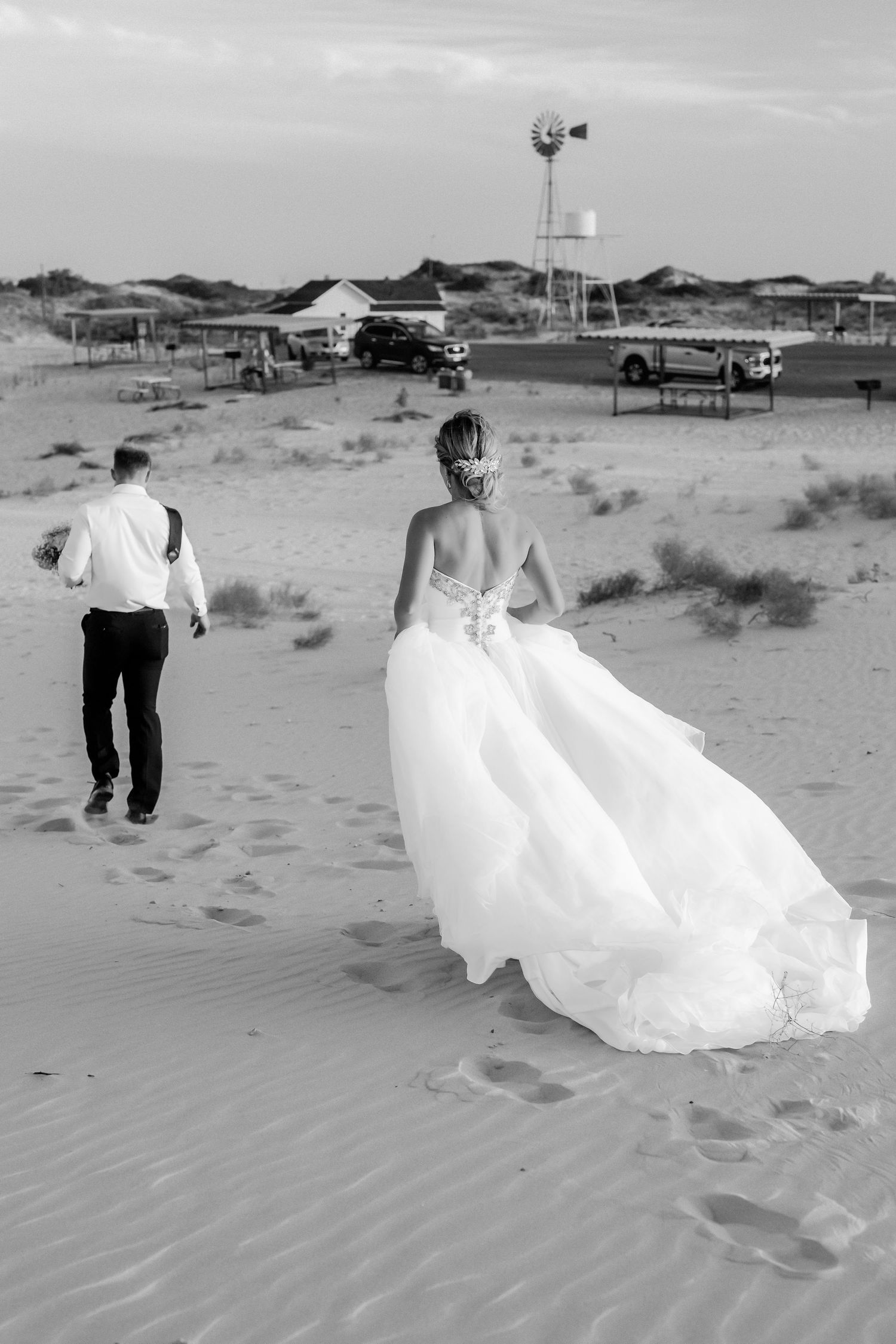 Black and white desert wedding photography sequence showing flowing dress movement in sand.
