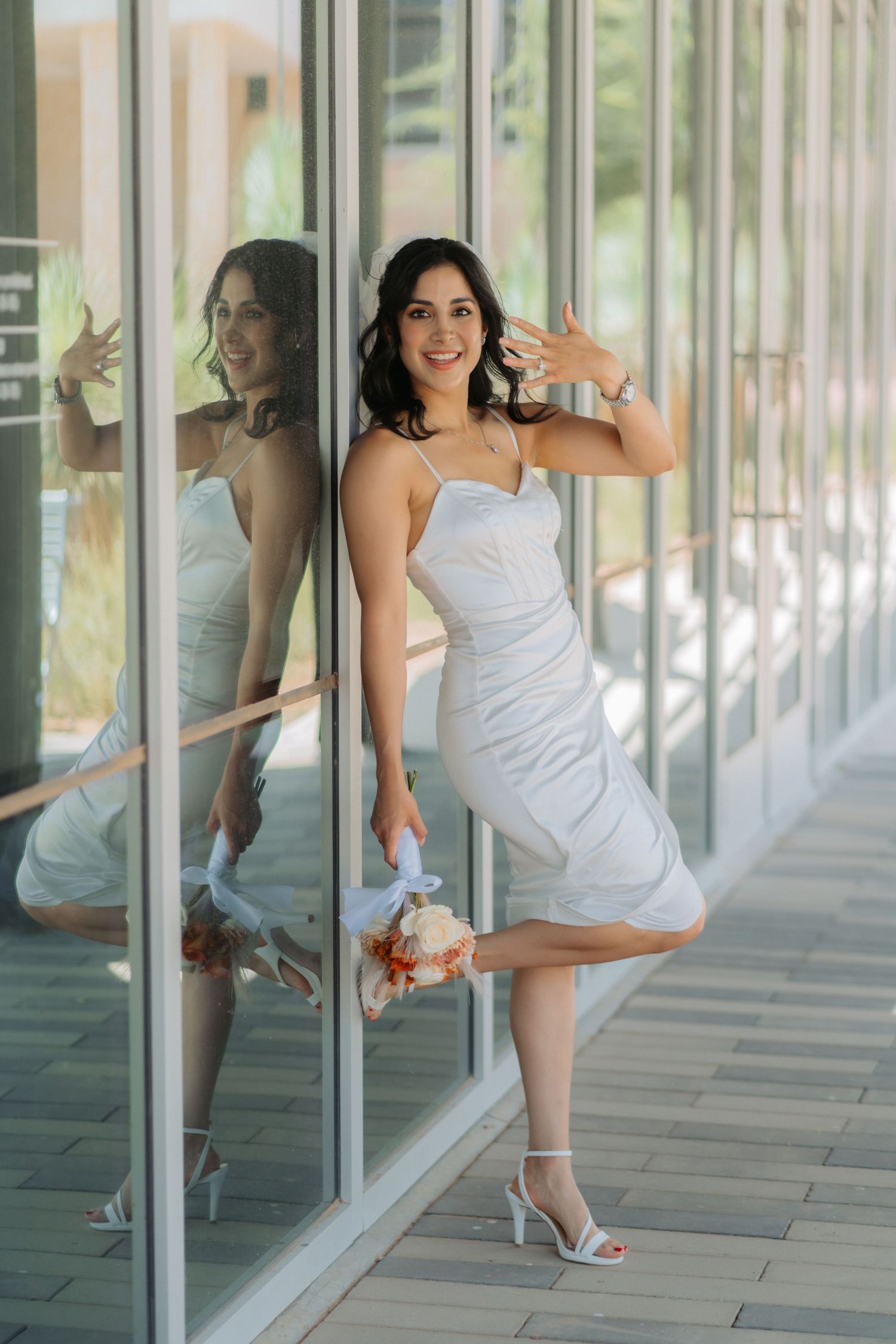 A bride celebrates her wedding showing off her bouquet and ring in Midland Texas.