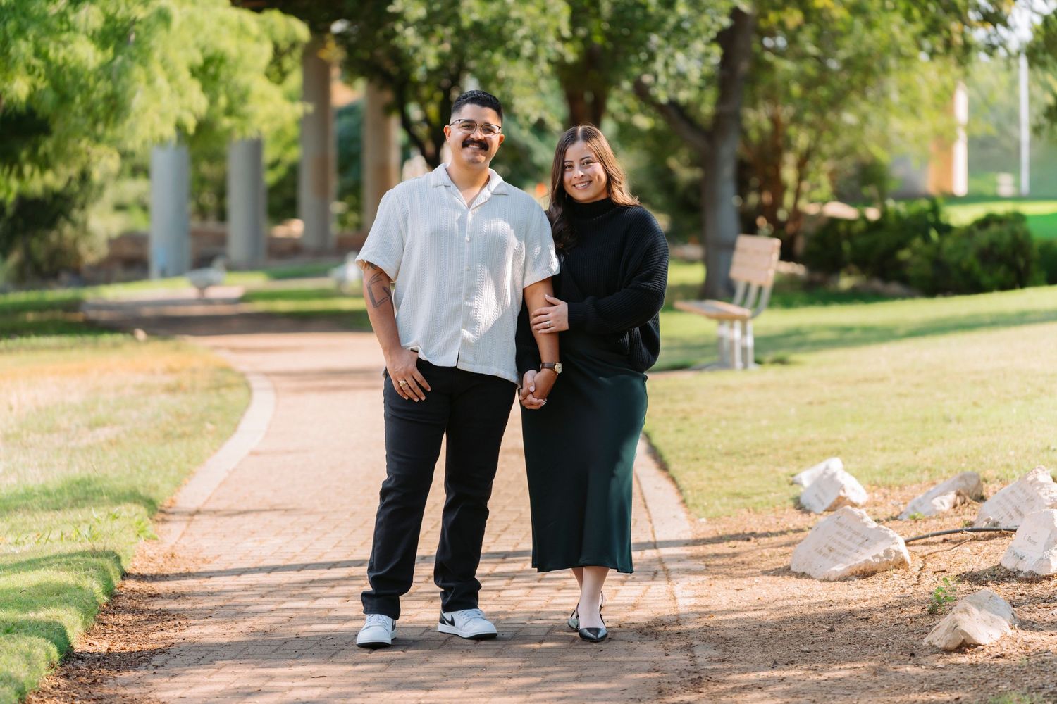 A series of connected photos showing a couple walking together on a tree-lined path in a park setting.