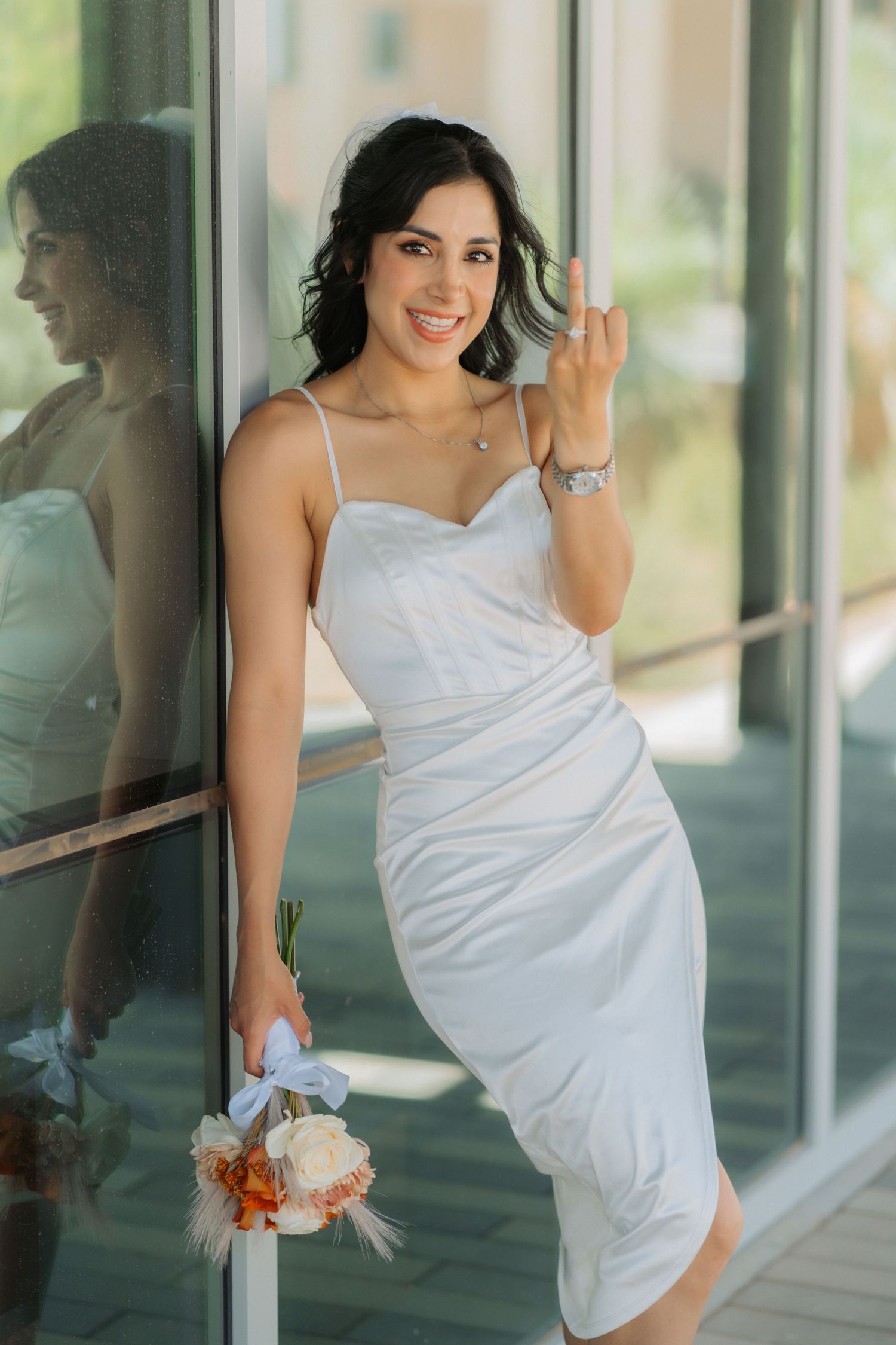 A bride celebrates her wedding showing off her bouquet and ring in Midland Texas