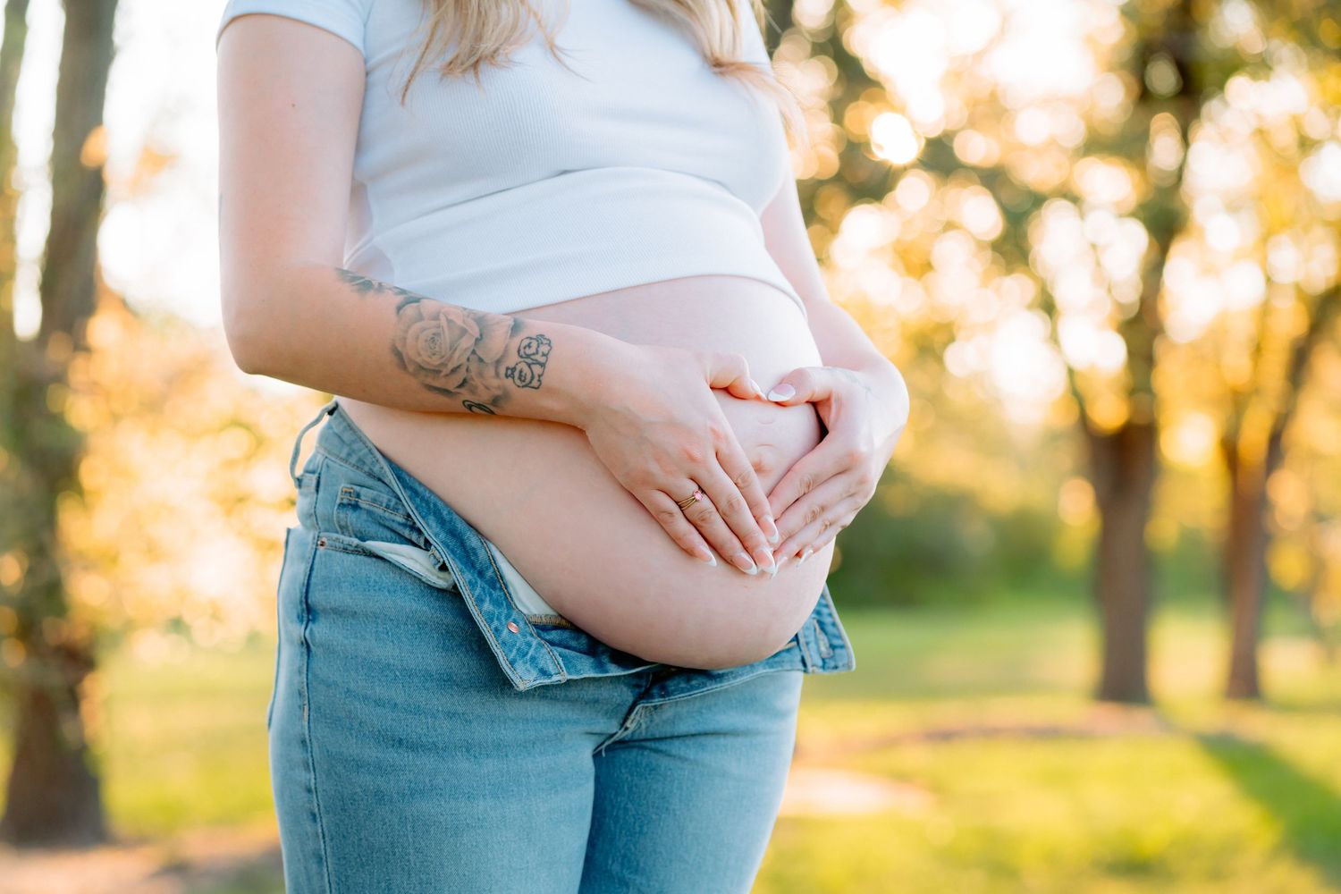 Maternity portrait session featuring gentle poses in natural outdoor lighting.
