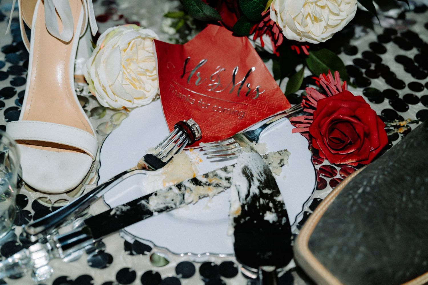 Close-up of elegant white and red roses in wedding floral arrangements.