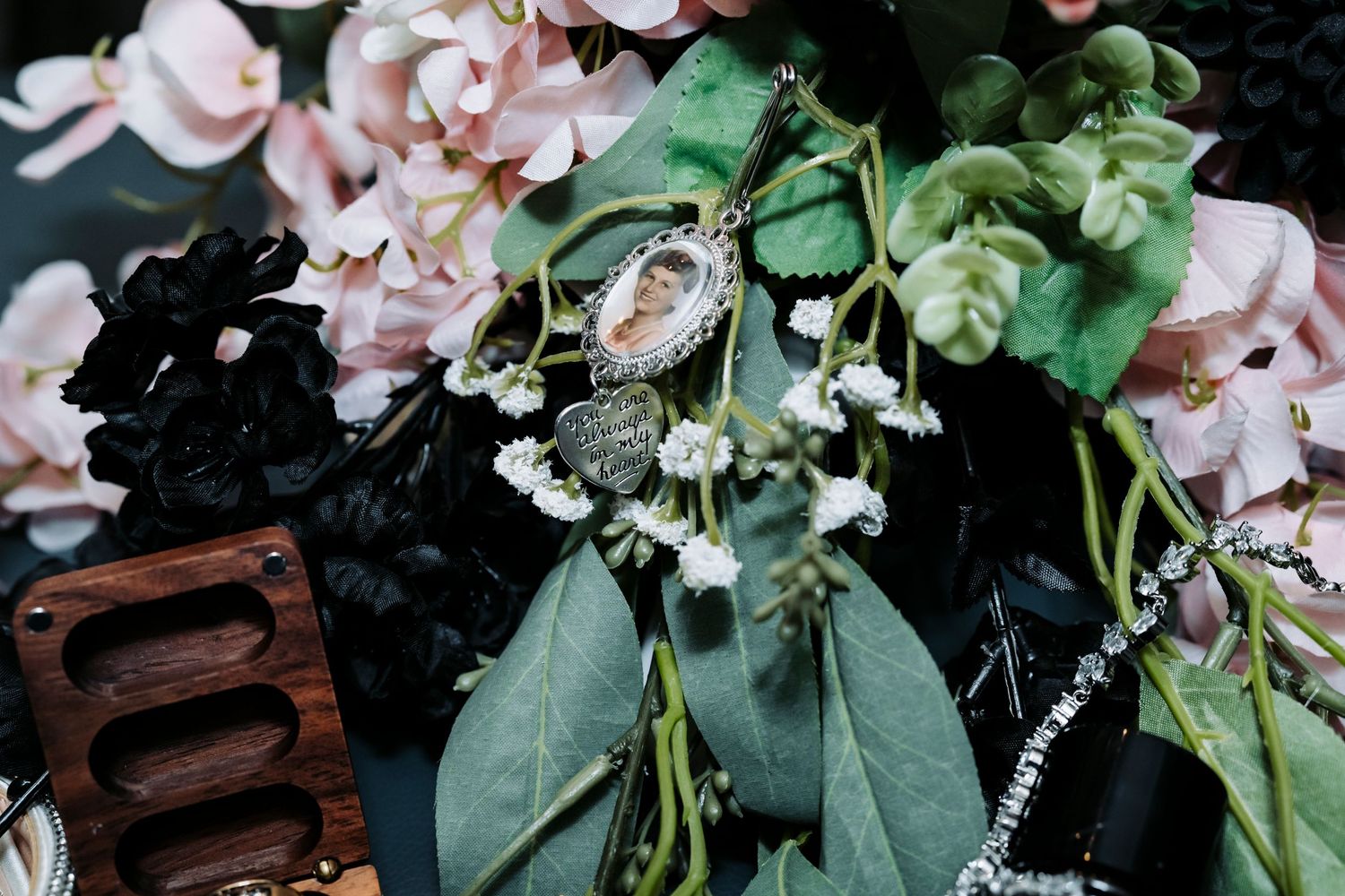 Wedding details featuring delicate pink flowers and green foliage.