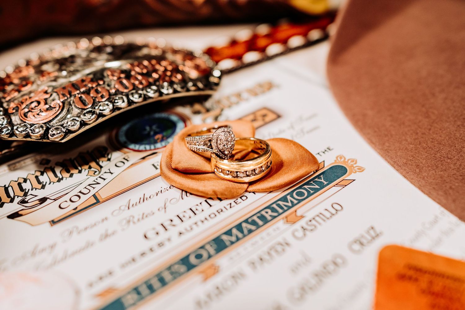 Wedding invitation and details photographed with warm copper tones.