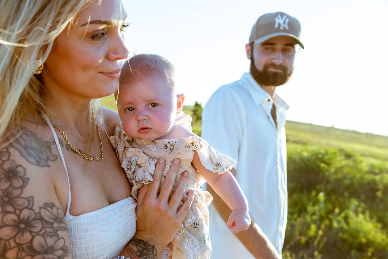 An intimate family portrait session at the beach with soft lighting.
