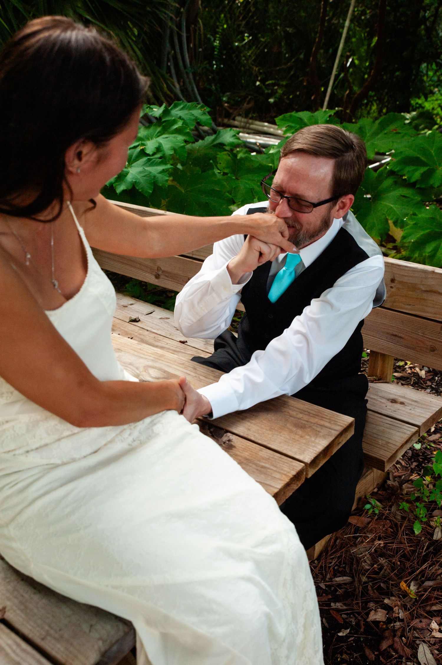 A sequence of romantic wedding photos showing intimate moments between a couple sitting on a wooden bench outdoors.