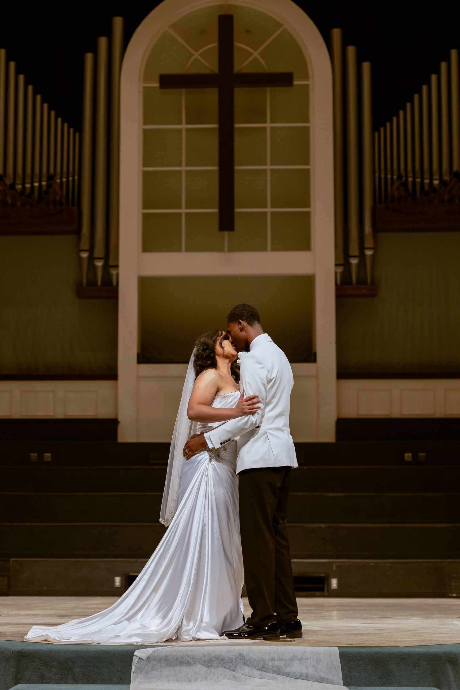 A romantic sequence of wedding photos showing a couple embracing in front of an elegant arched building entrance.