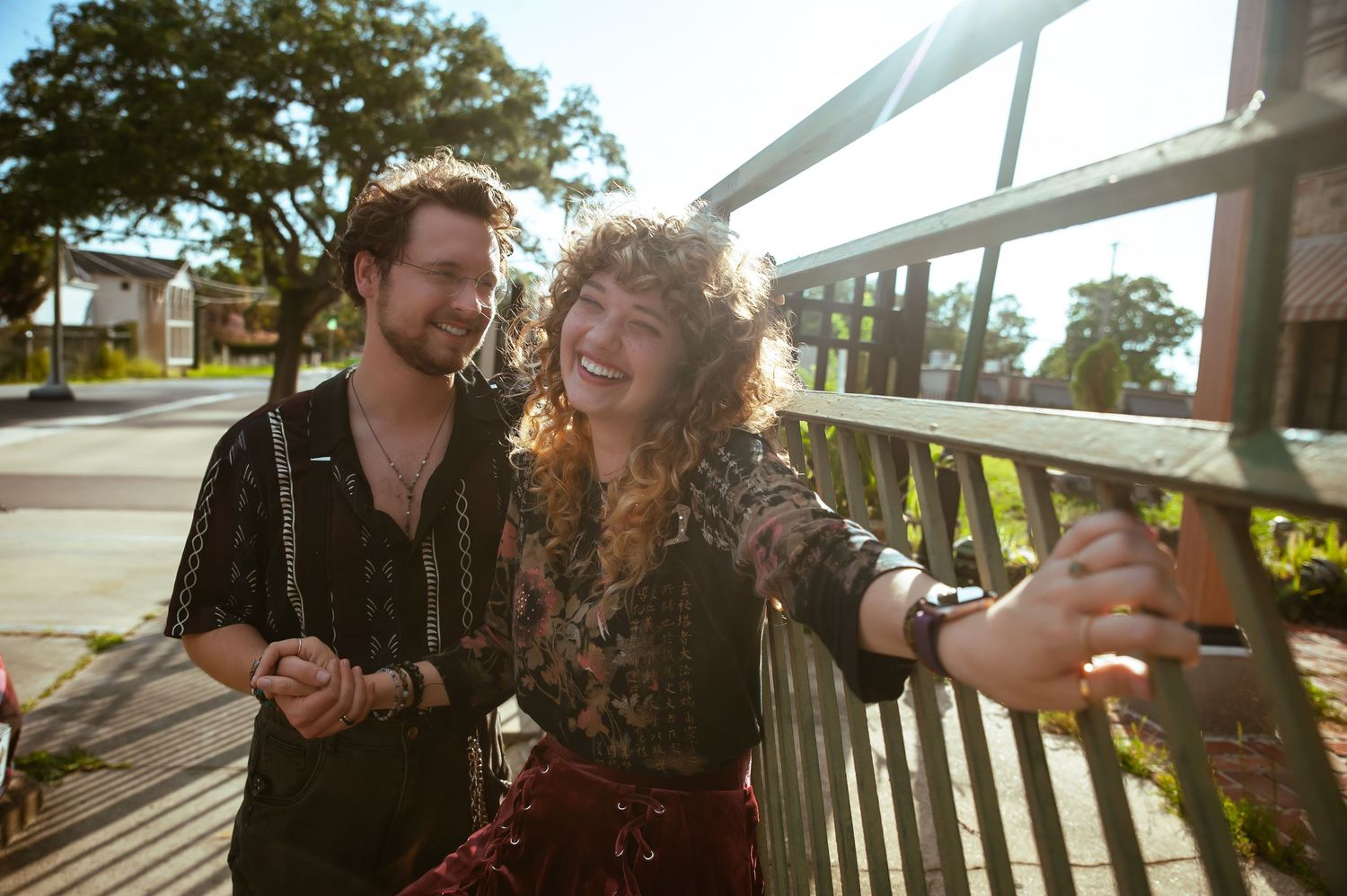 A couple shares intimate moments together on a sunny porch in a series of candid shots.
