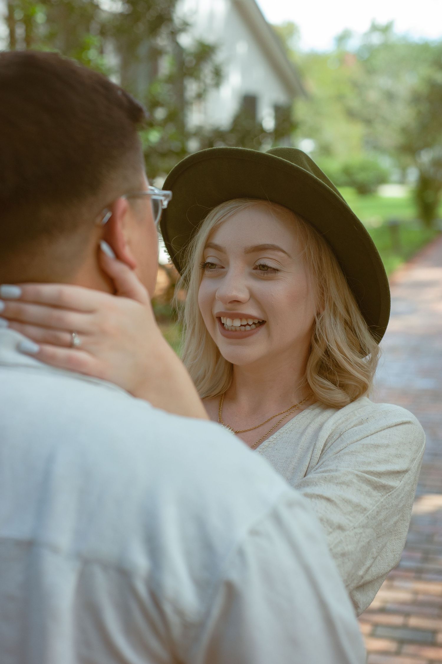 A romantic moment shared between two people on a brick pathway.