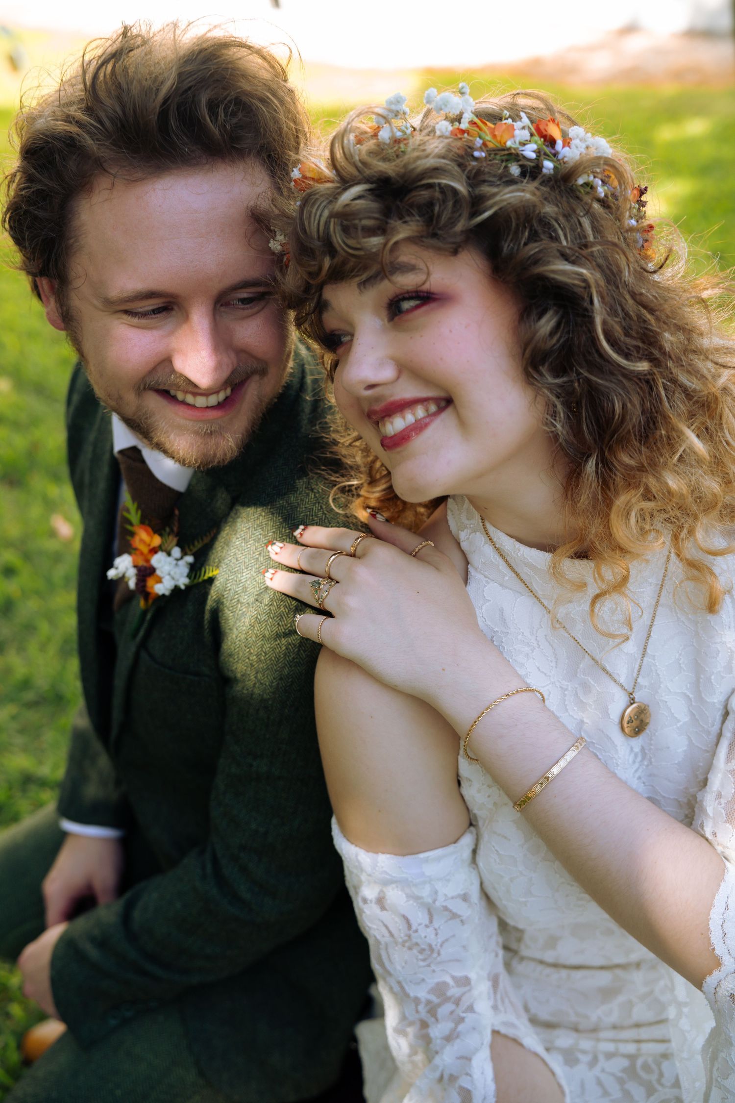 A couple in wedding attire shares intimate moments outdoors in a series of romantic candid photographs.